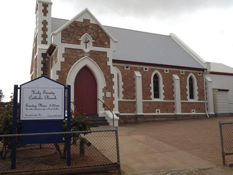 front entrance of large red brick church