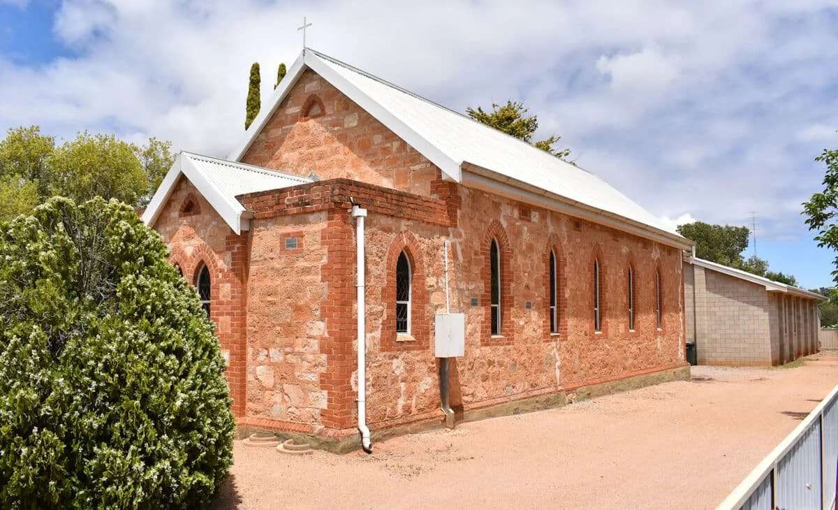 Impressive red brick church with white roof