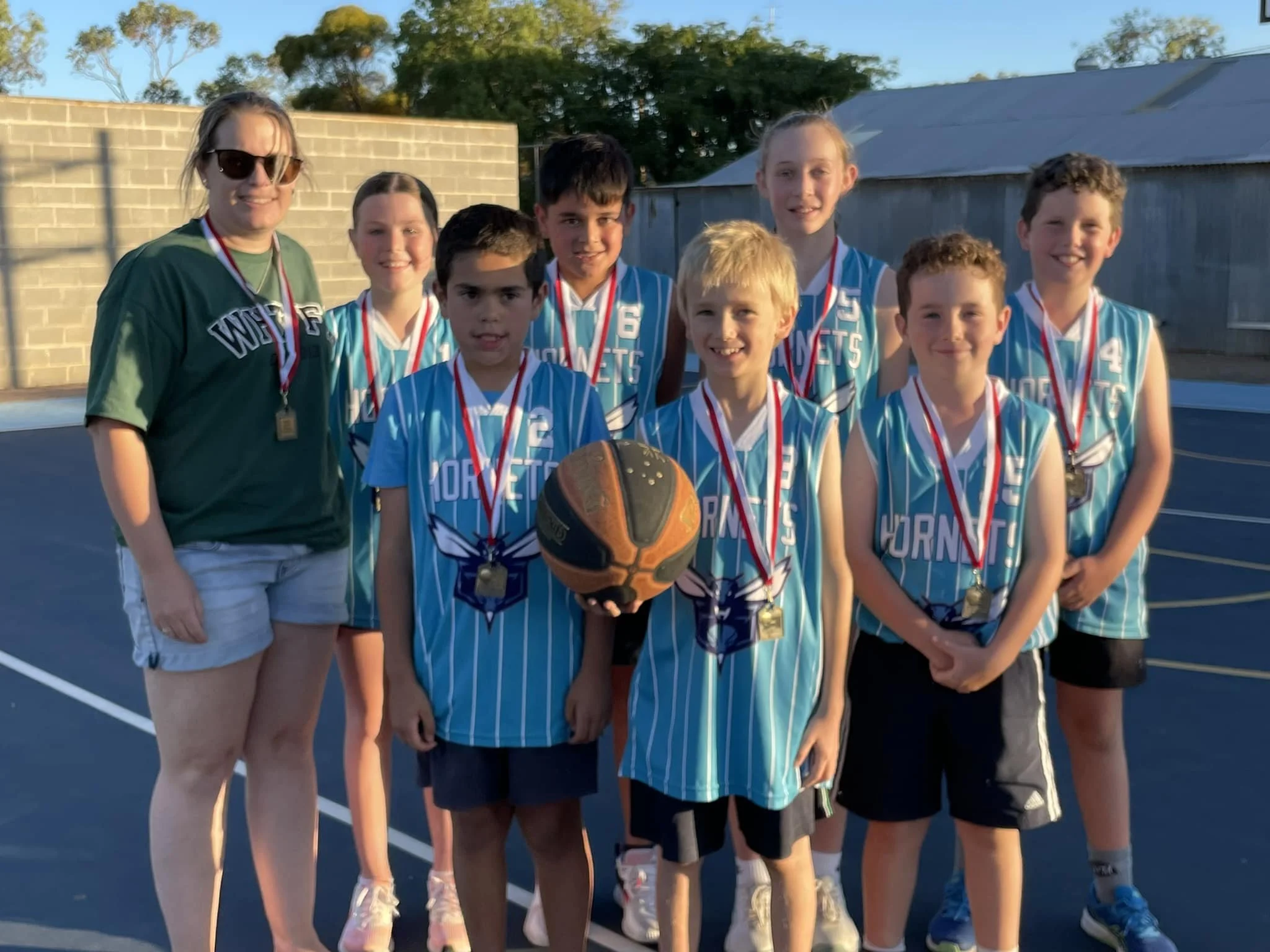 Group of young basketballers smiling 