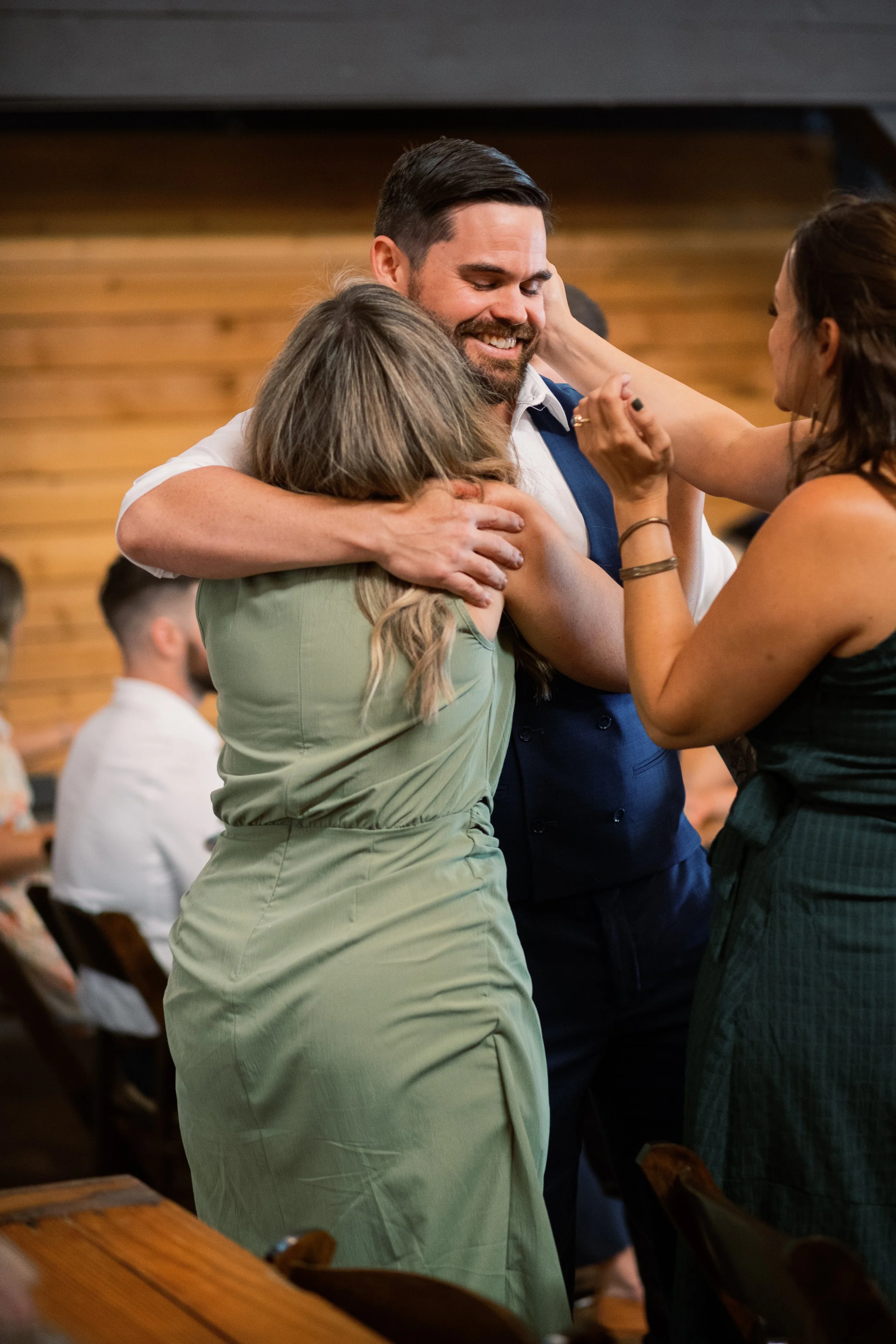 Groom dancing with a family member on the dance floor during the reception