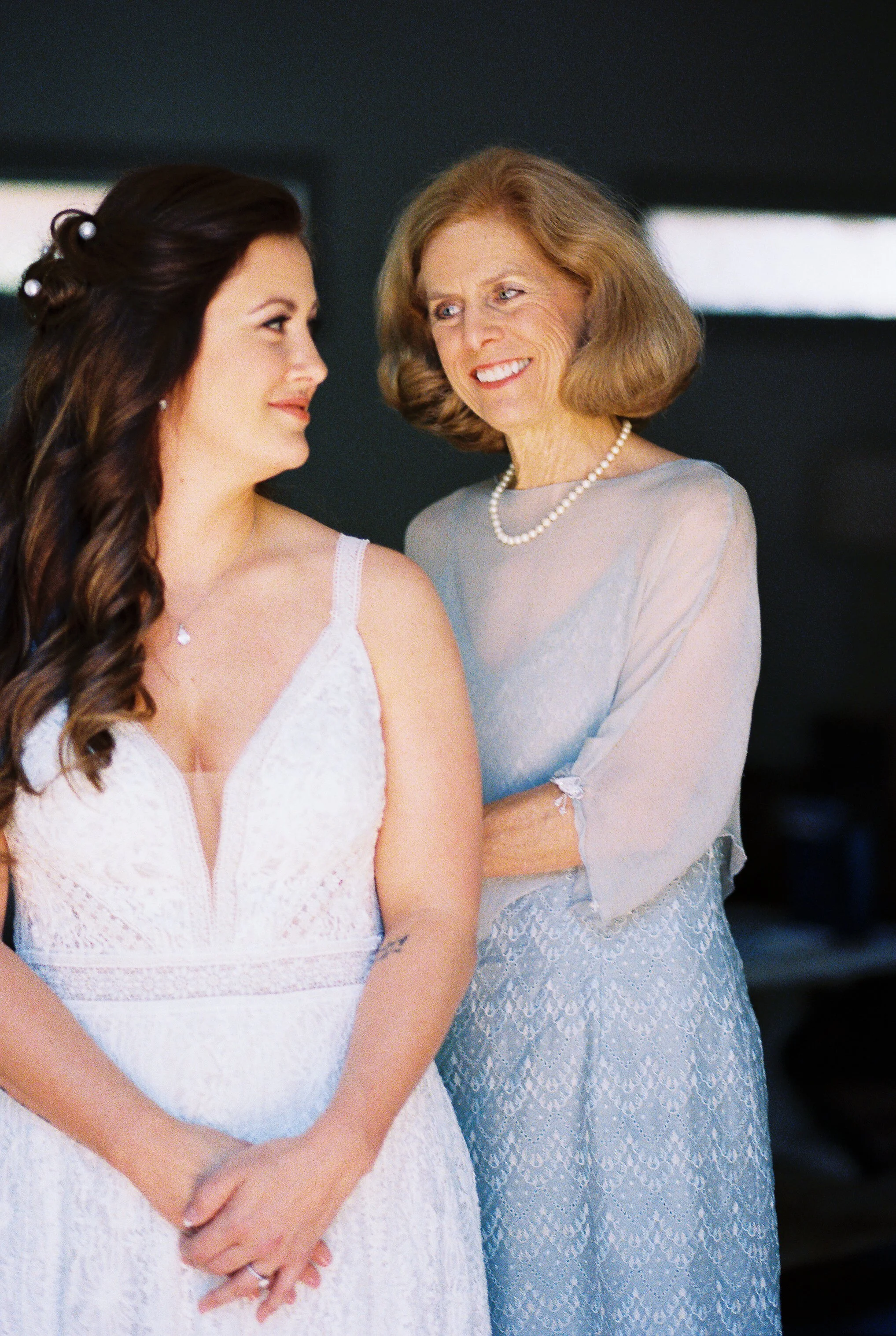 Bride and her mother sharing a warm embrace before the ceremony