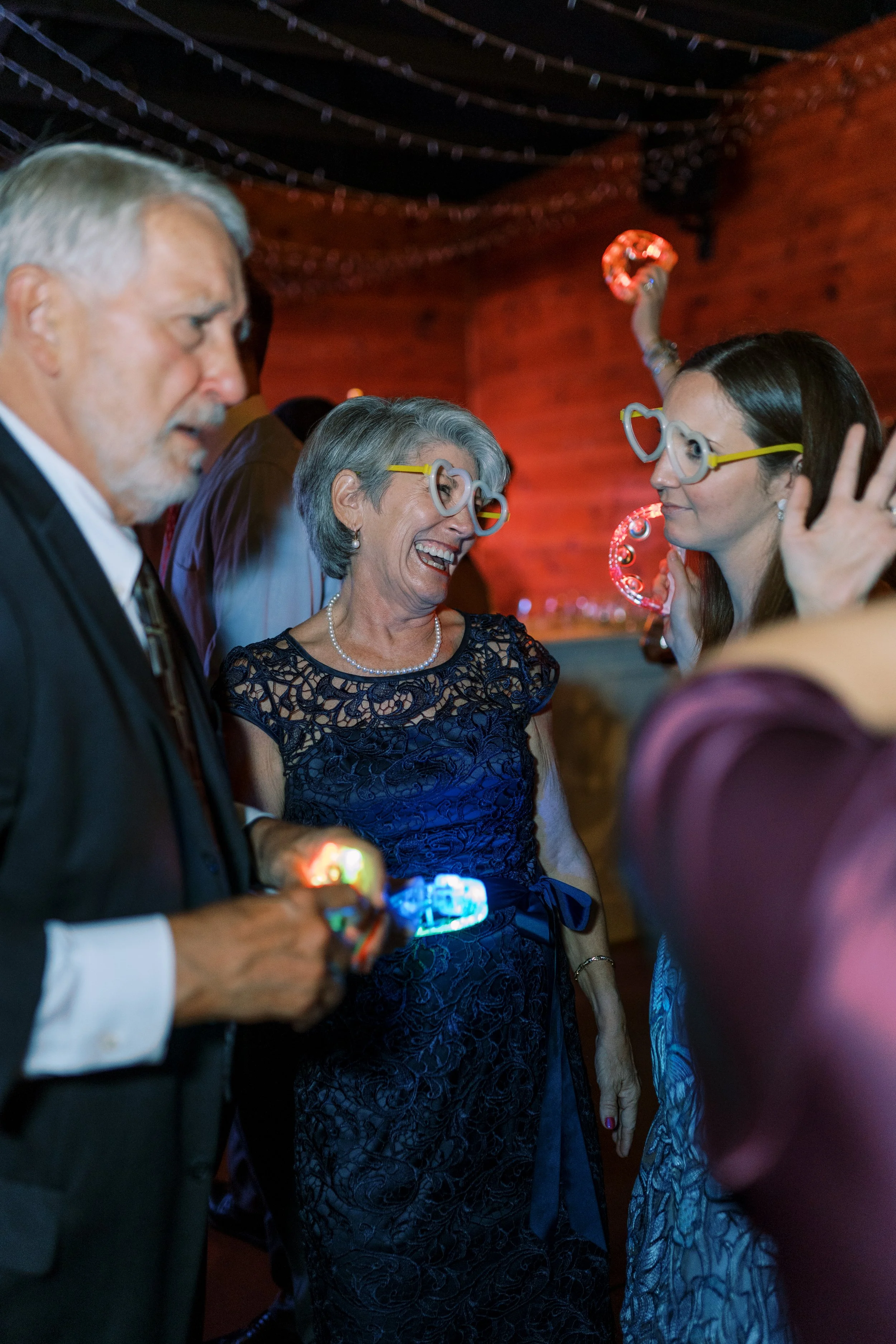 Guests dancing and celebrating on the dance floor at night