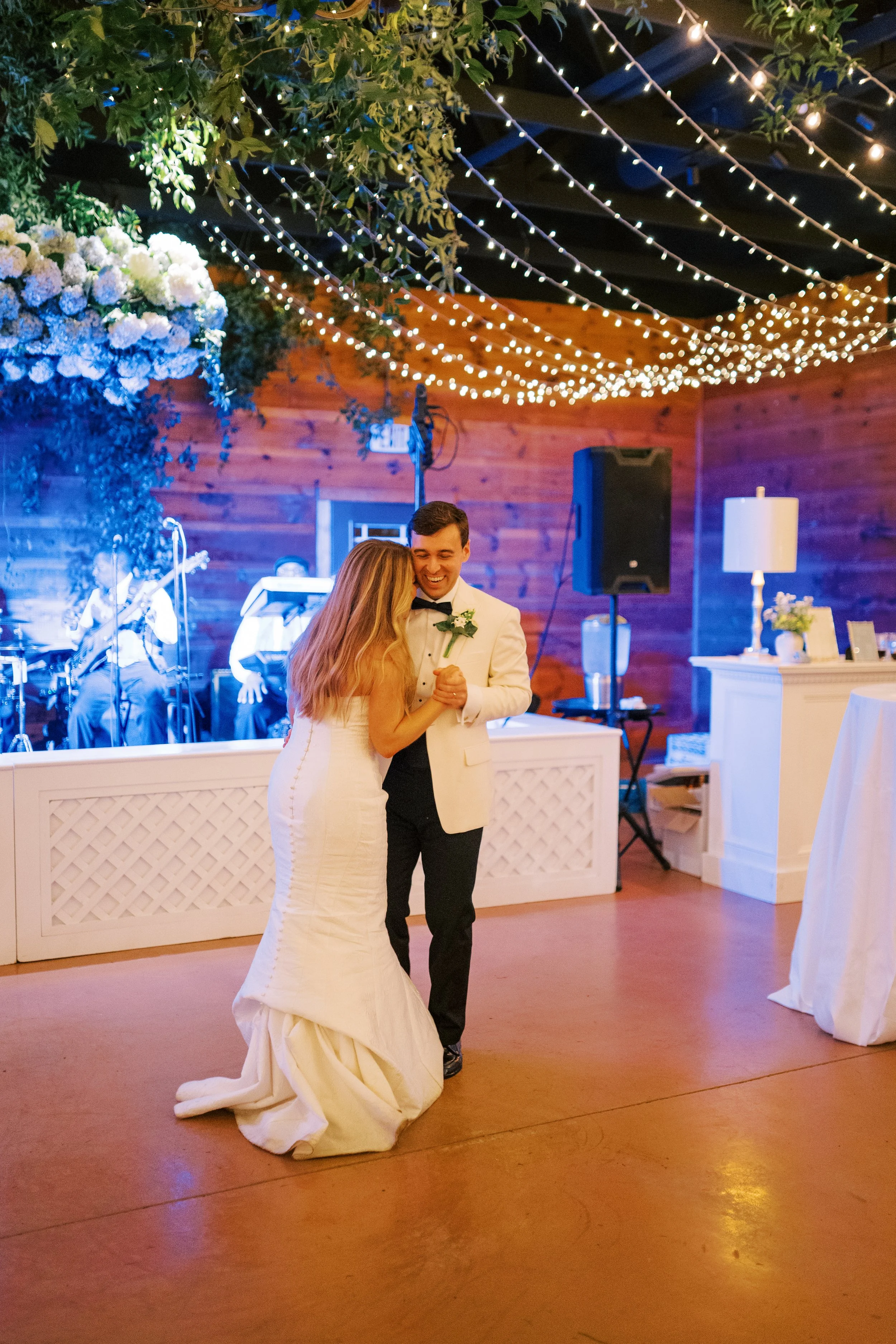 Bride and groom sharing their first dance on the reception dance floor
