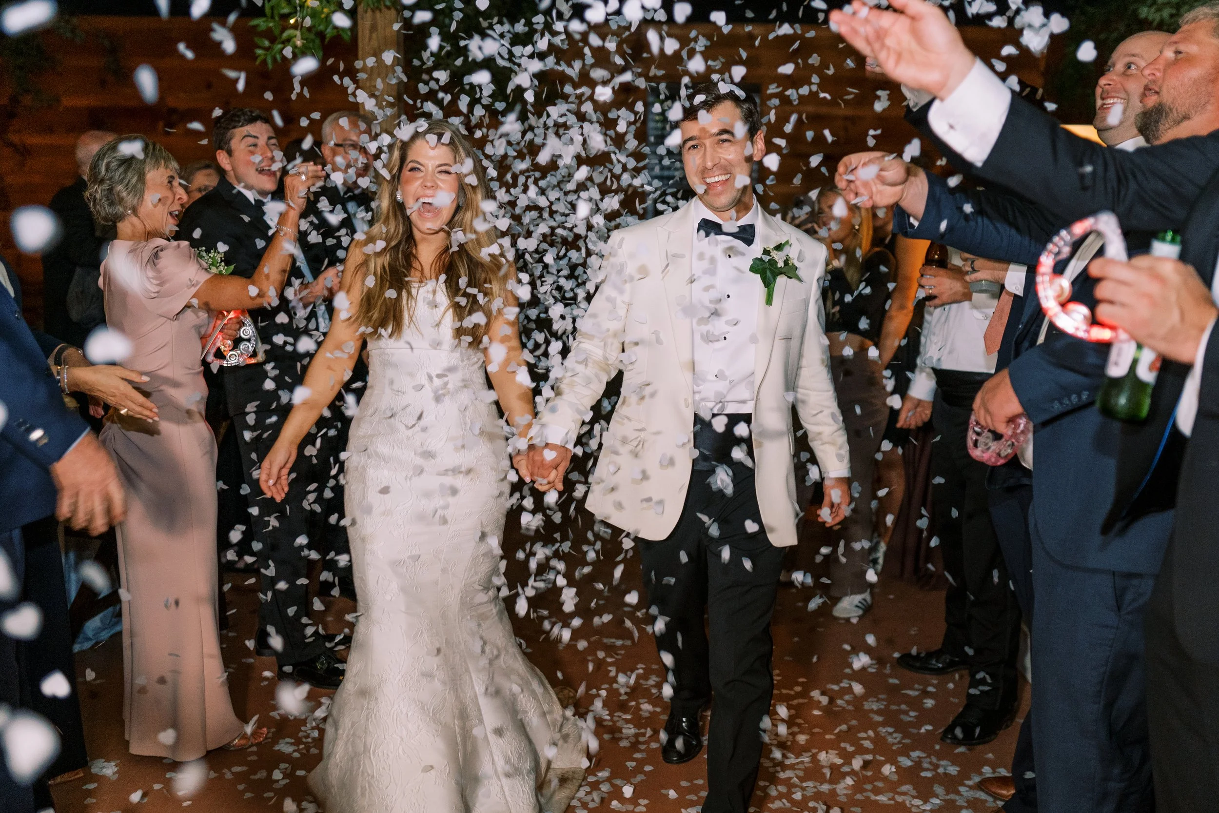 Bride and groom walking through a confetti sendoff