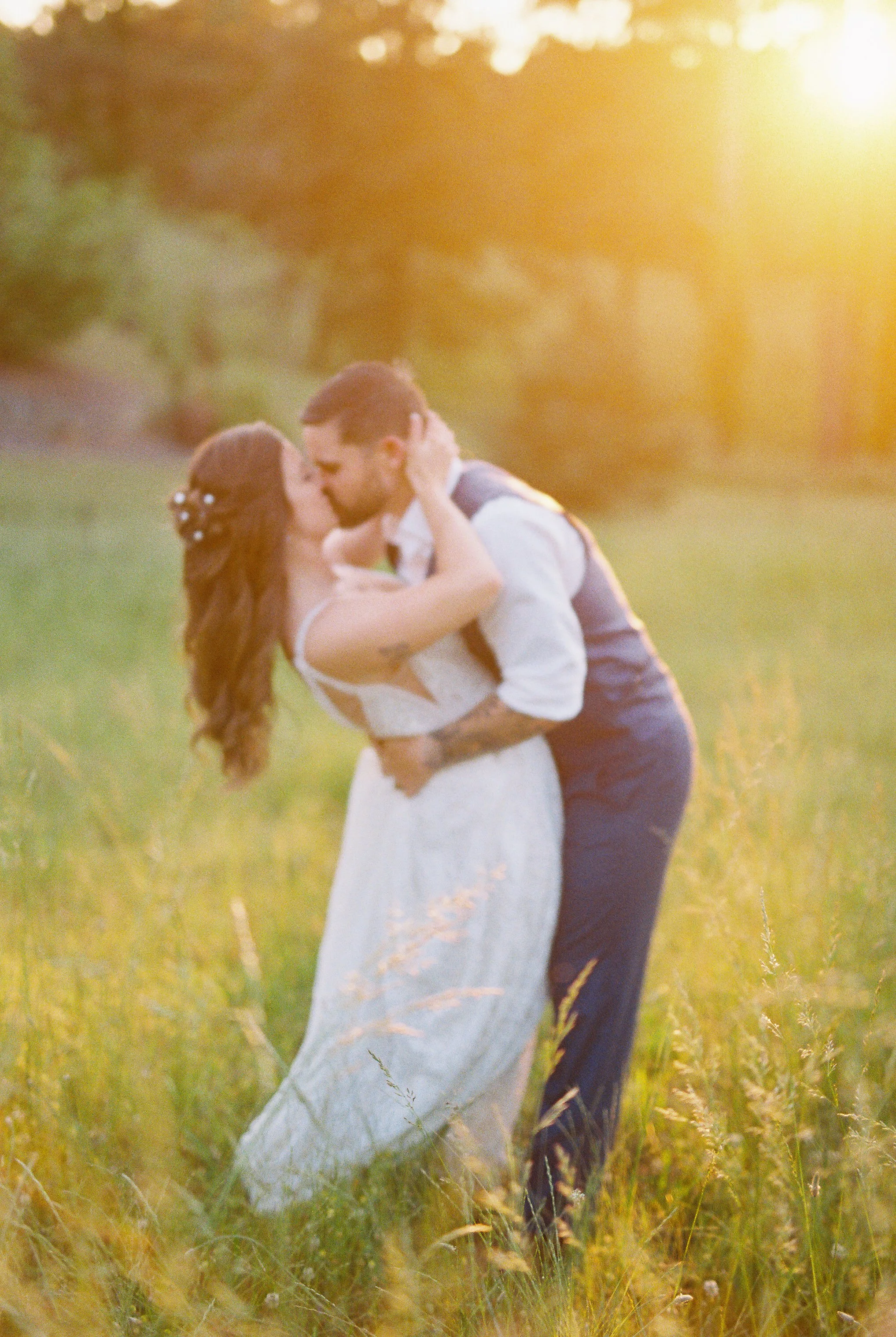 Bride and groom walking together through the golden field
