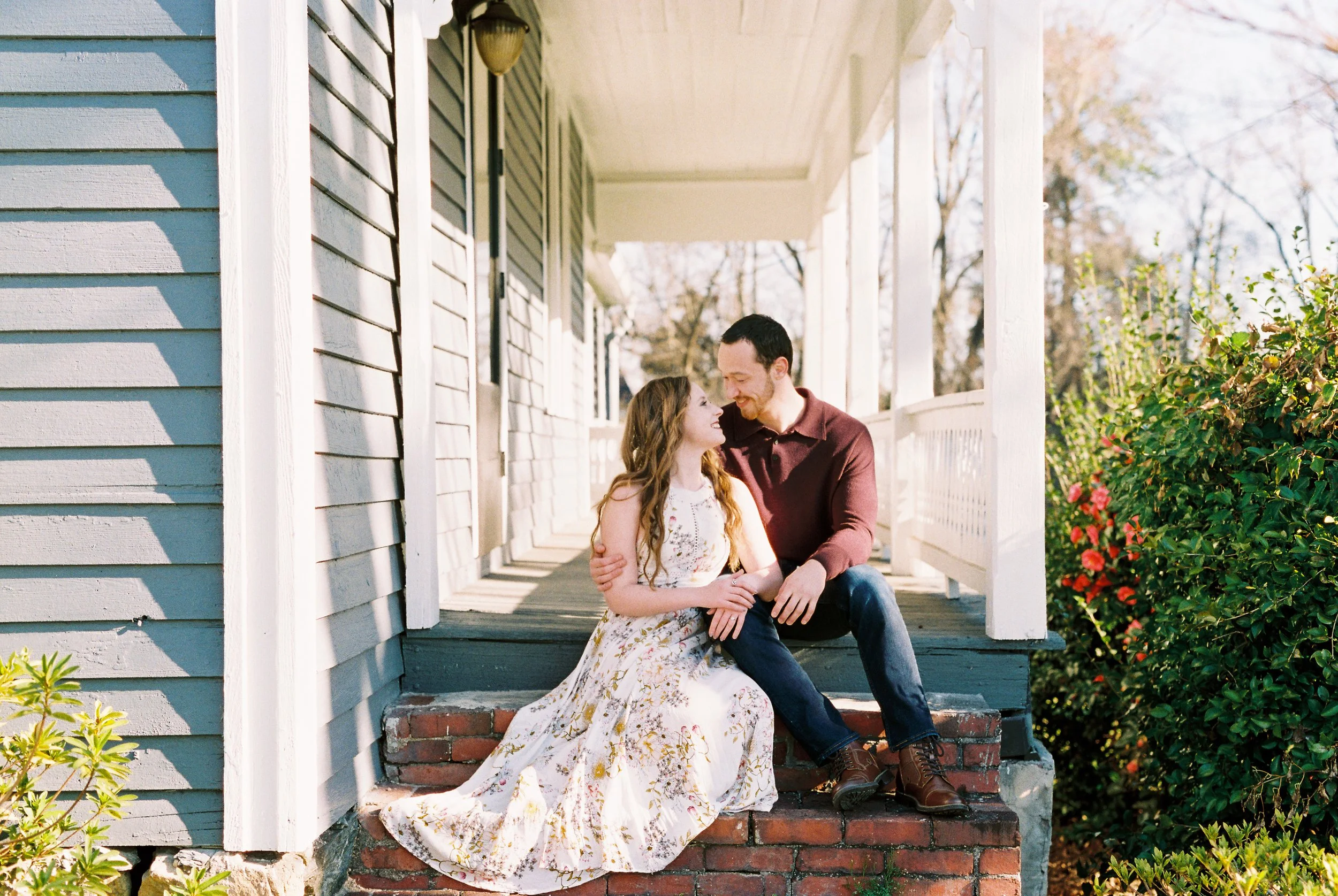 Conner and Maddie share a tender moment nose to nose on the porch steps of a historic home in Dallas, Georgia.