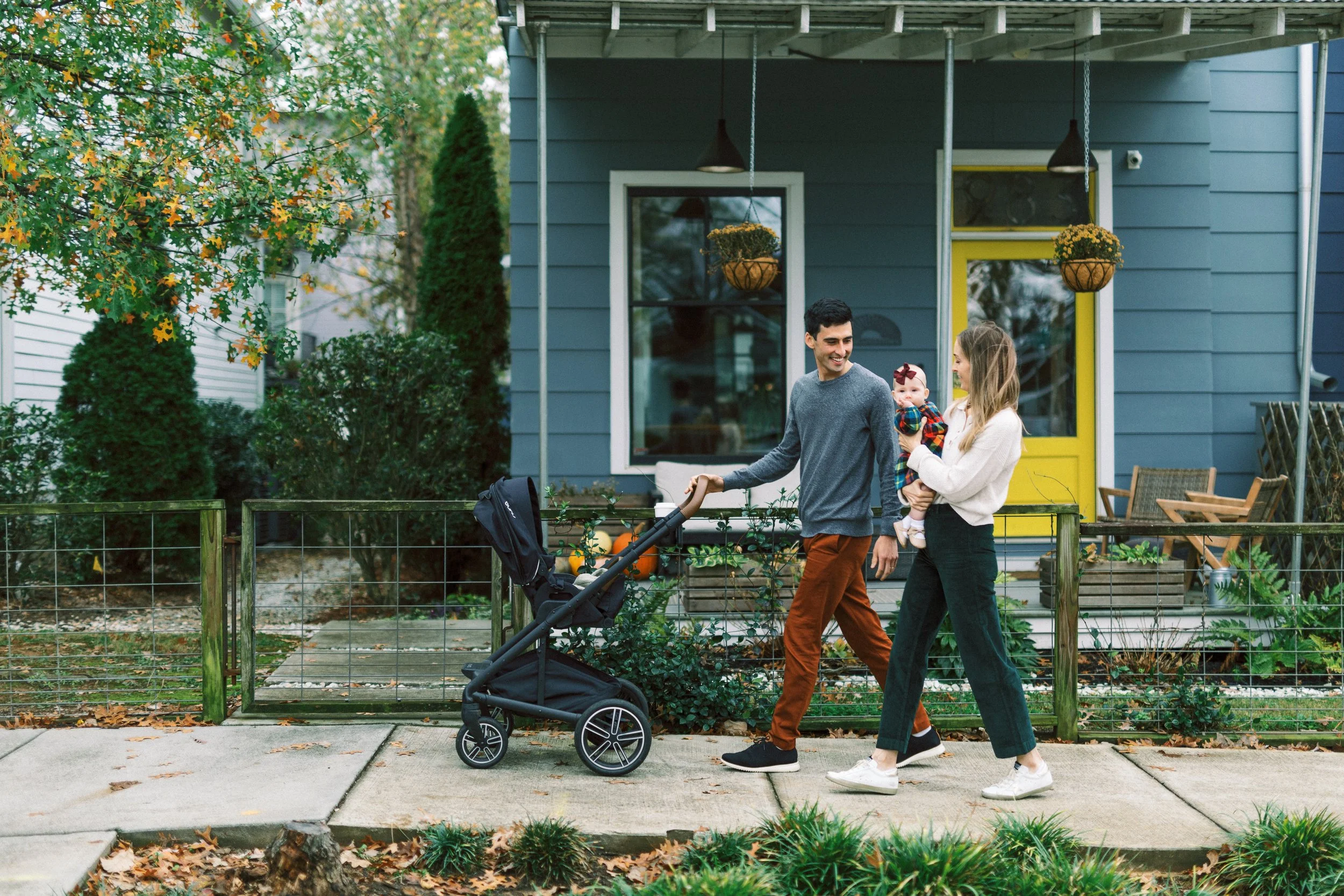 Family walking with the stroller down the sidewalk, seen from behind, Reynoldstown, Atlanta, Georgia