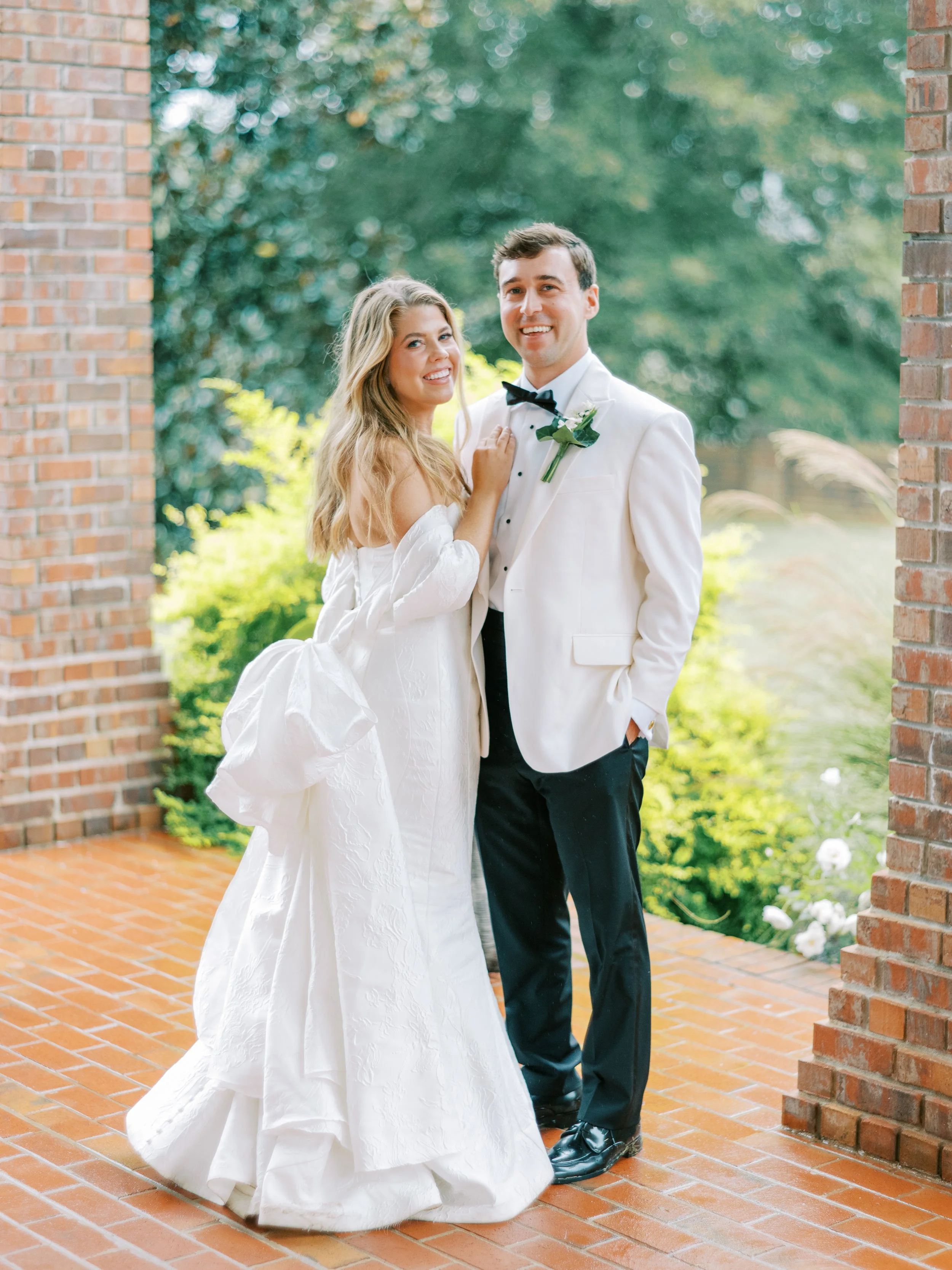 Bride and groom portrait near the venue's brick exterior