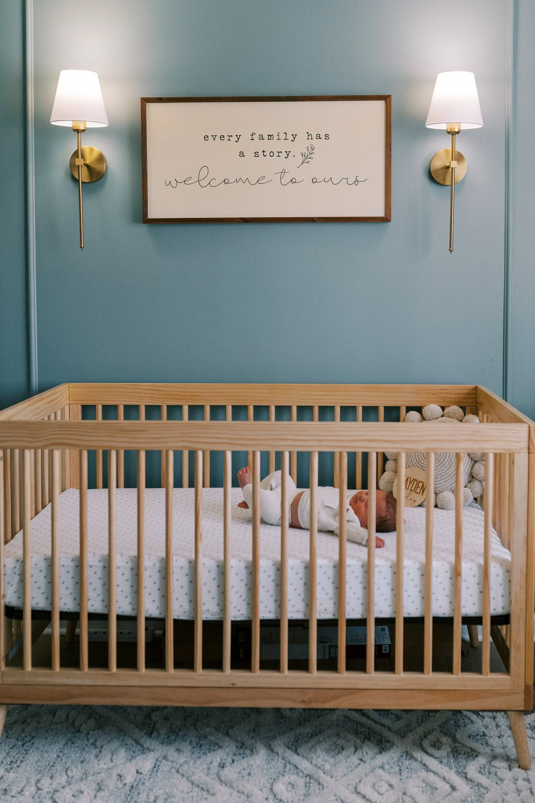 Parents standing together in the nursery smiling down at their newborn baby, Roswell, Georgia