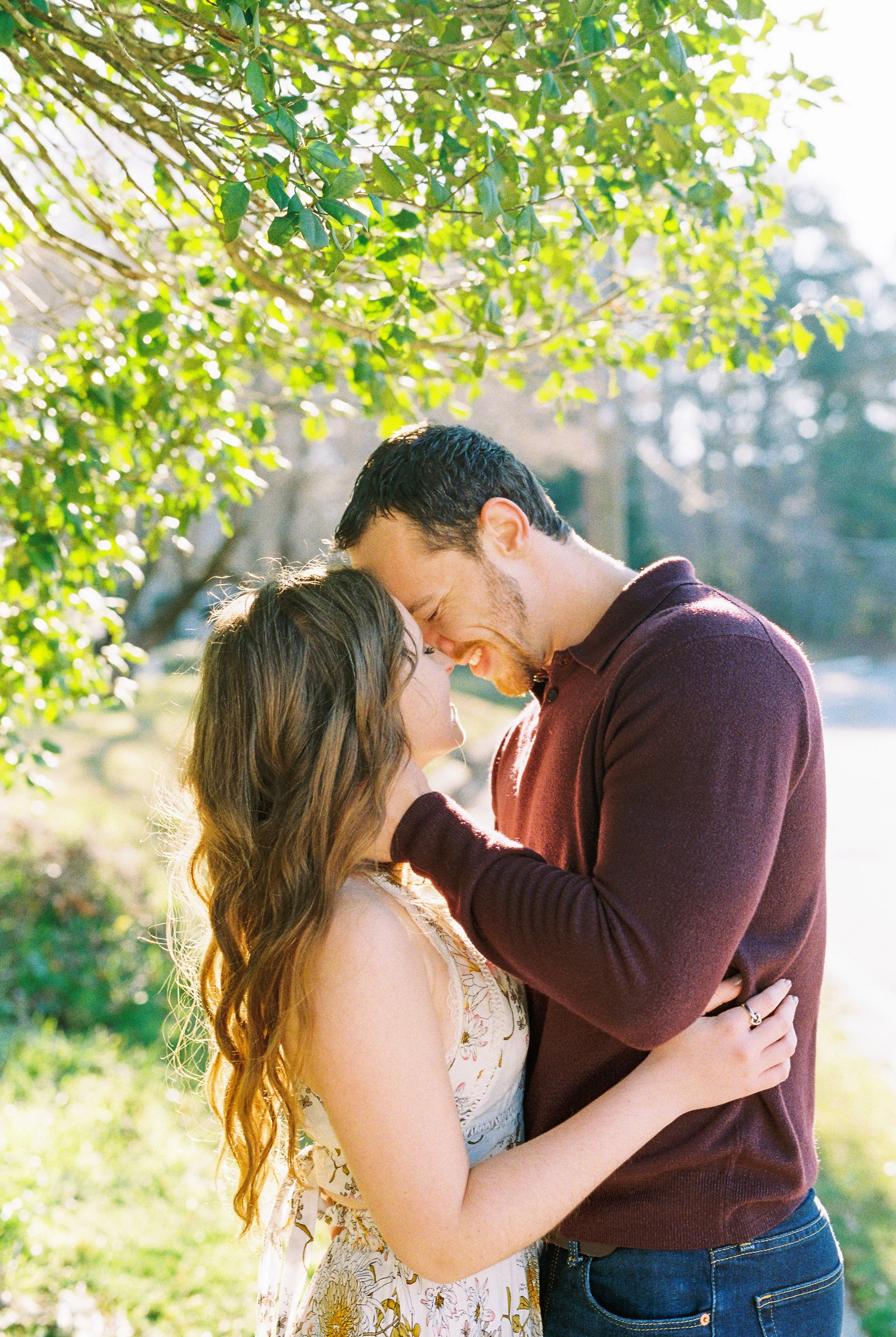Conner laughs as he and Maddie embrace forehead to forehead beneath a tree in Dallas, Georgia.