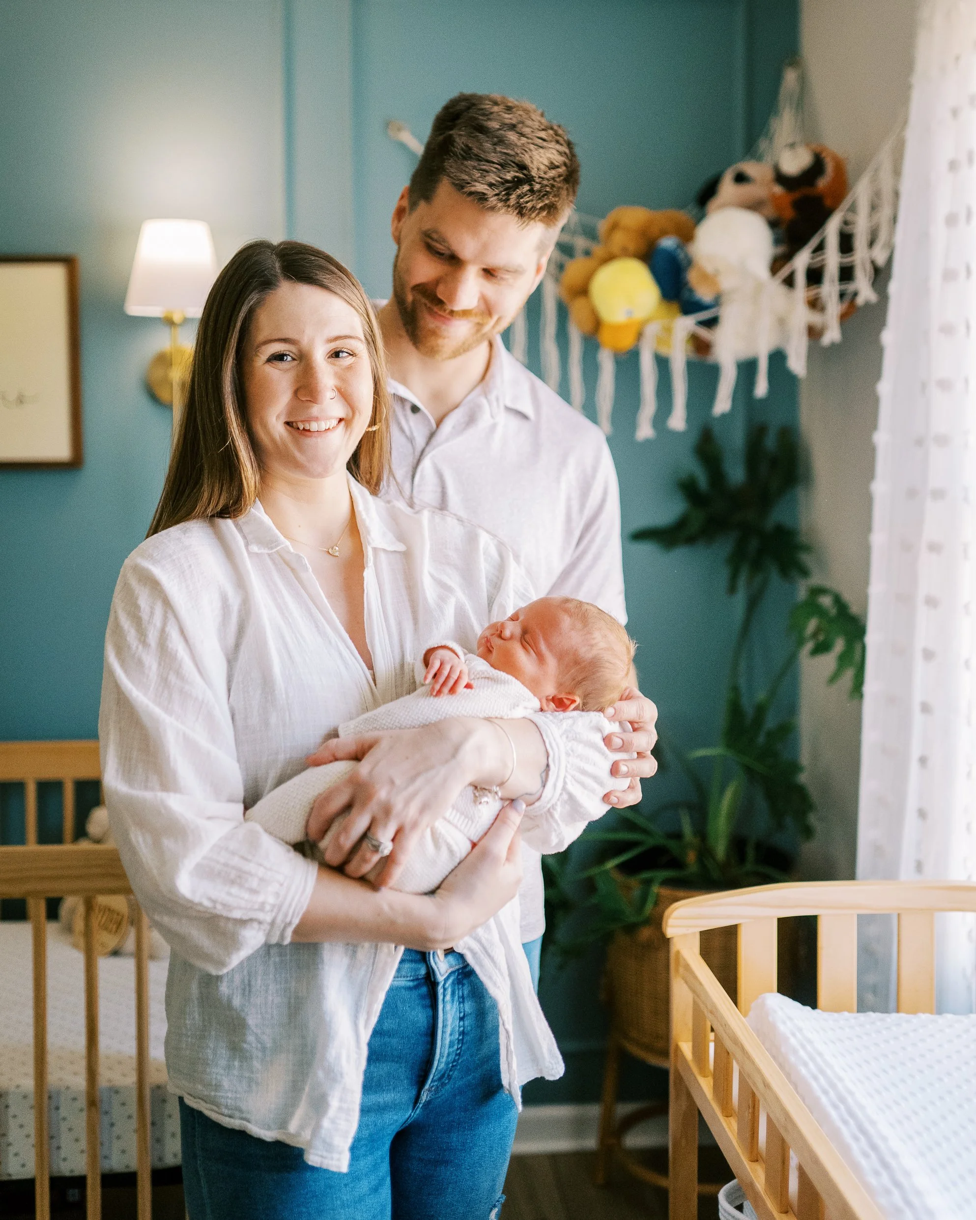 Wooden crib in the nursery beneath the framed 'welcome to ours' sign, Roswell, Georgia