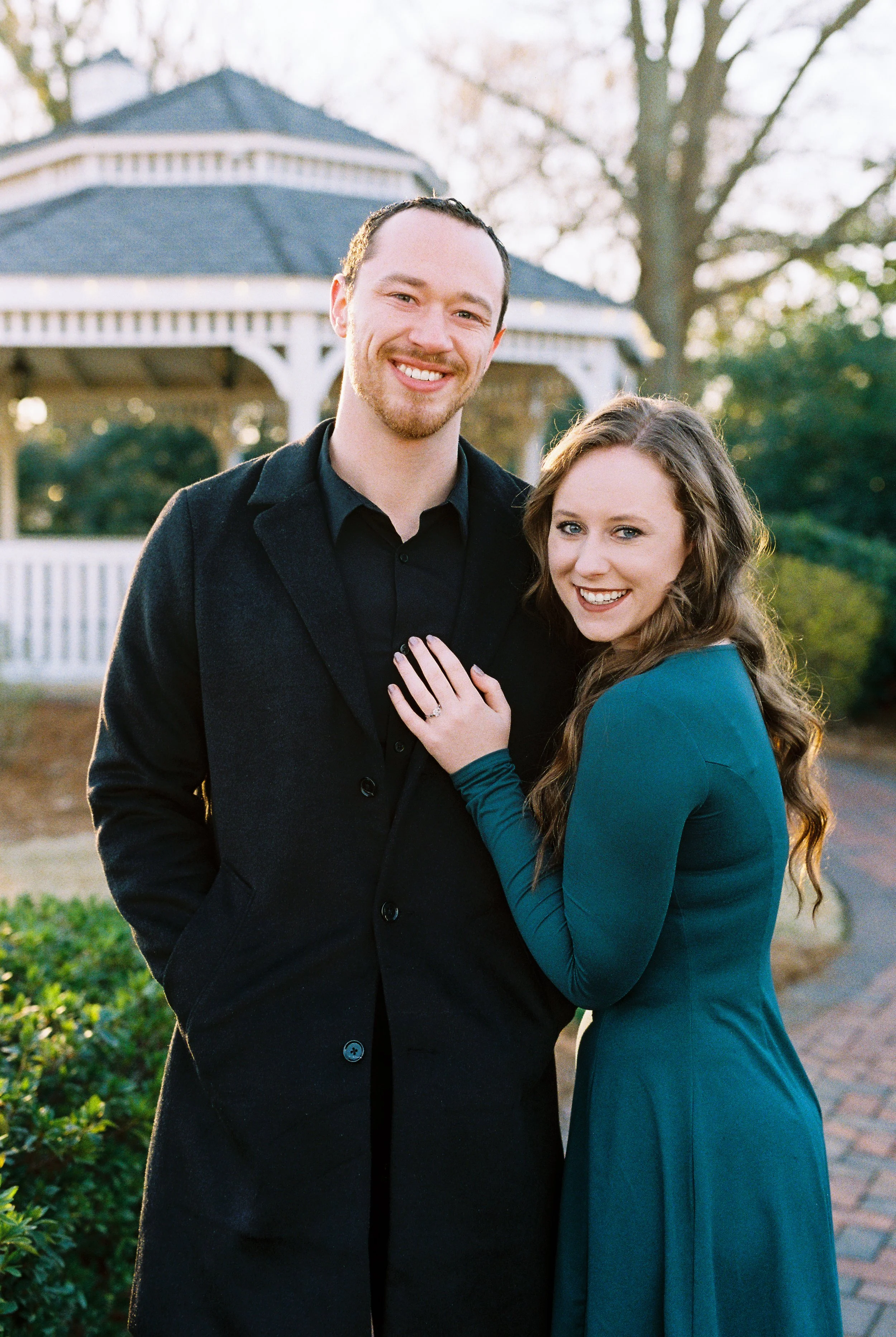 Conner and Maddie smile at the camera close together in front of a gazebo in Dallas, Georgia.