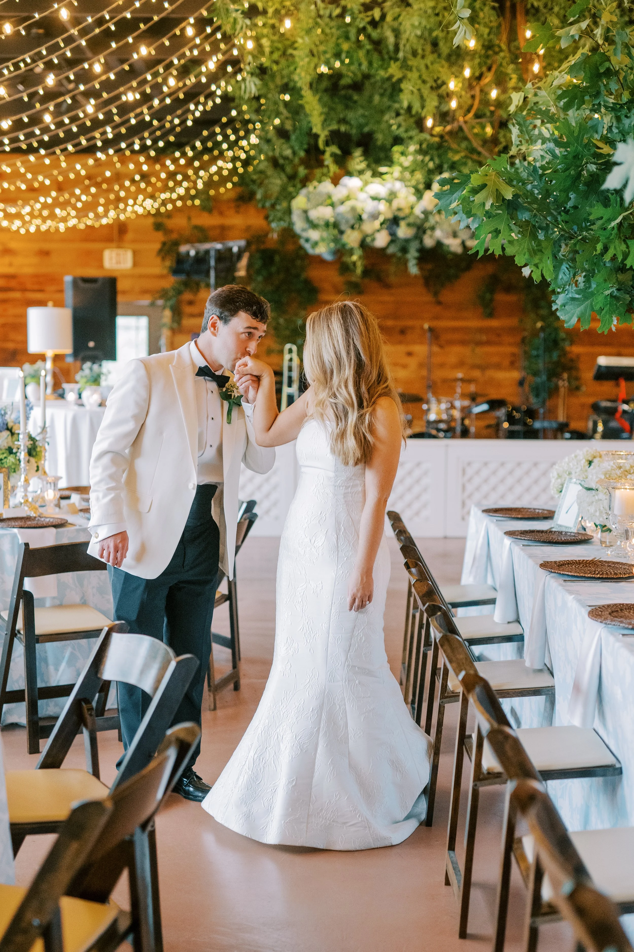 Bride and groom portrait in the reception venue aisle between tables