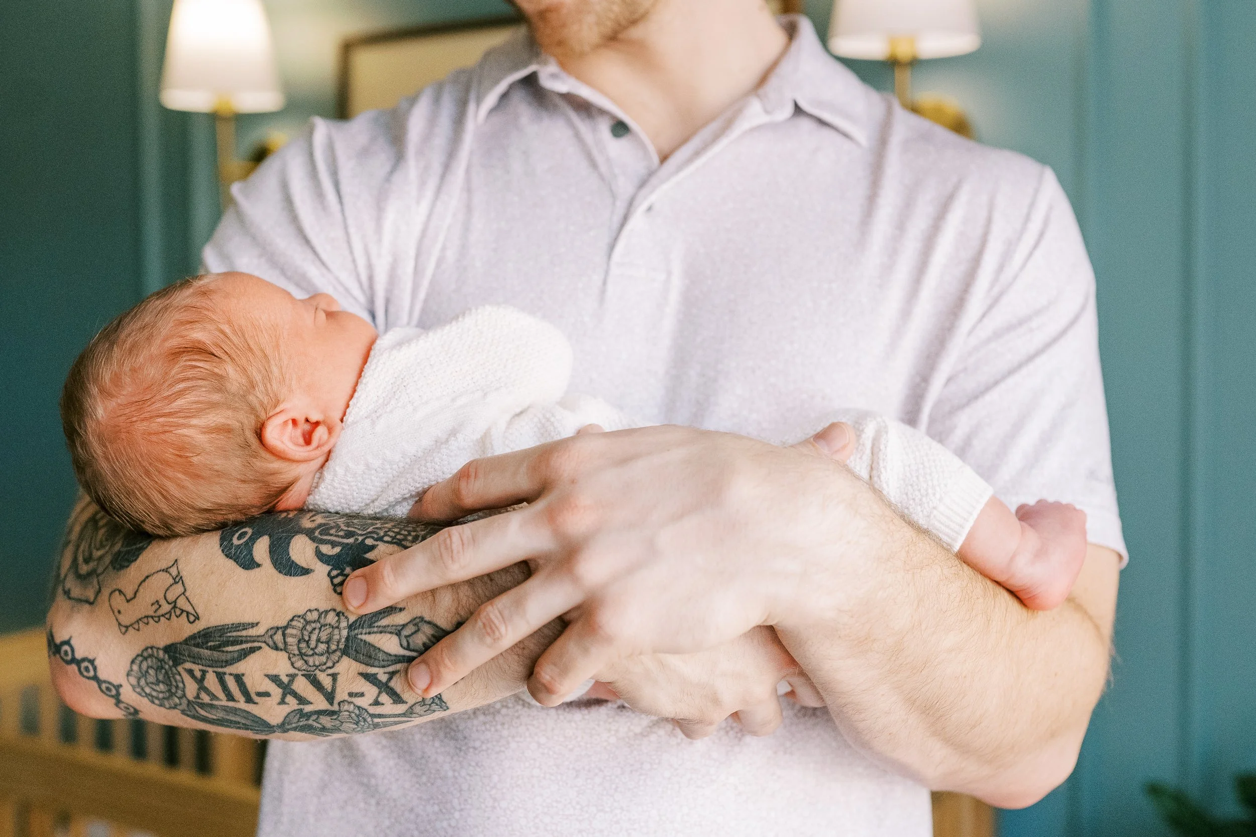 Close-up of mother's hands gently cradling her newborn baby's head, Roswell, Georgia