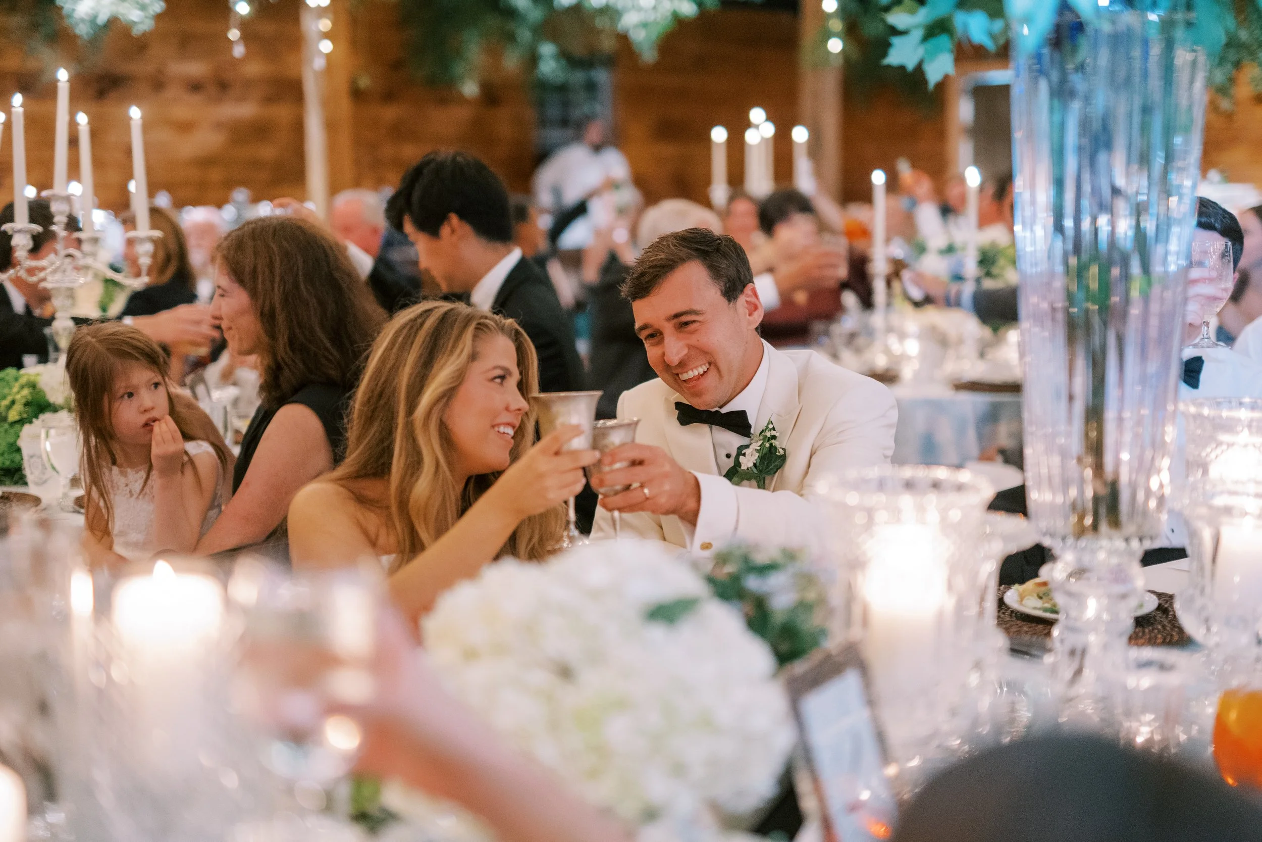Wedding party toasting with champagne at the reception table