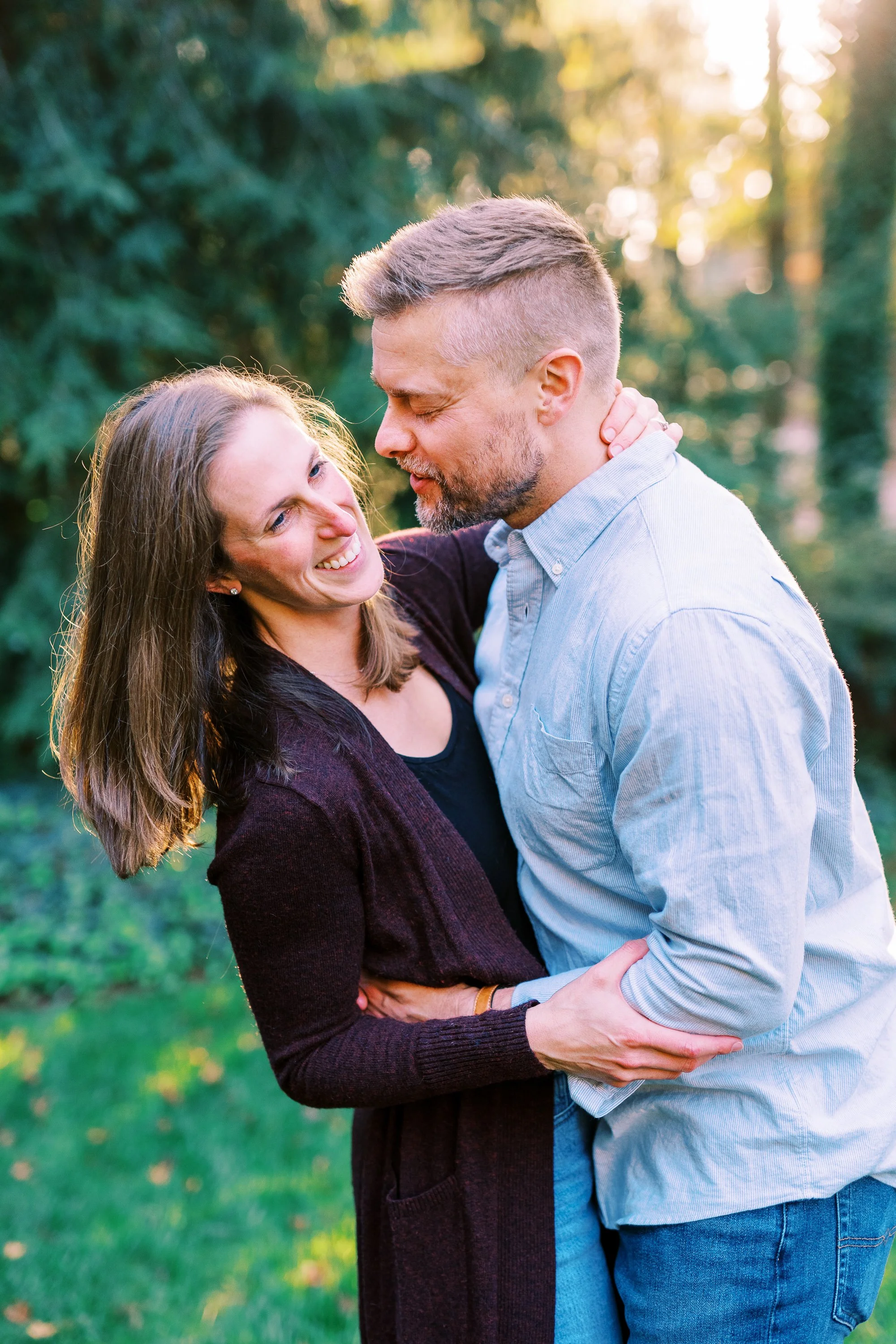 Holly and Chris smiling and gazing at each other outdoors in Dunwoody, Georgia