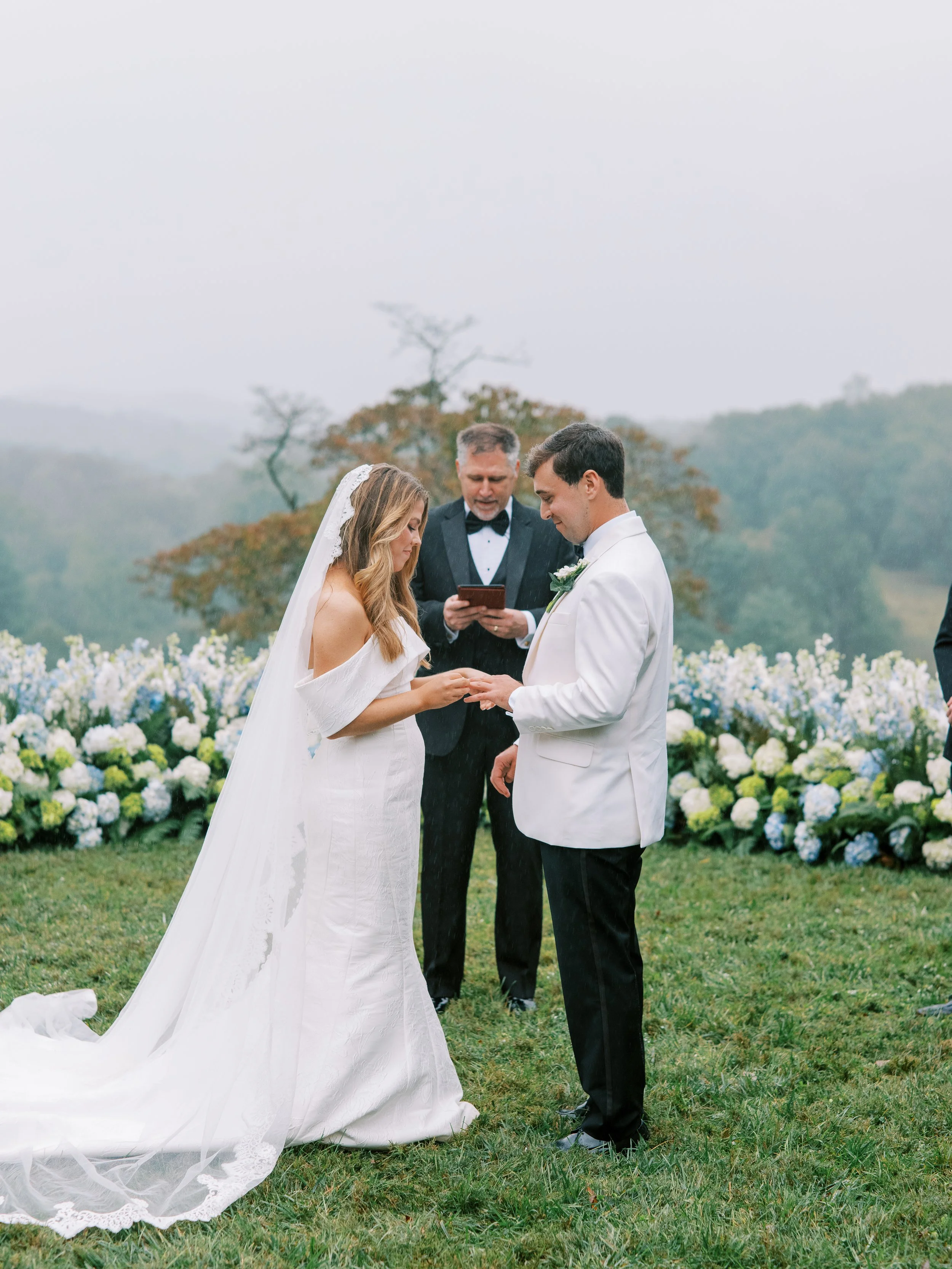 Couple exchanging vows with a sweeping mountain valley view