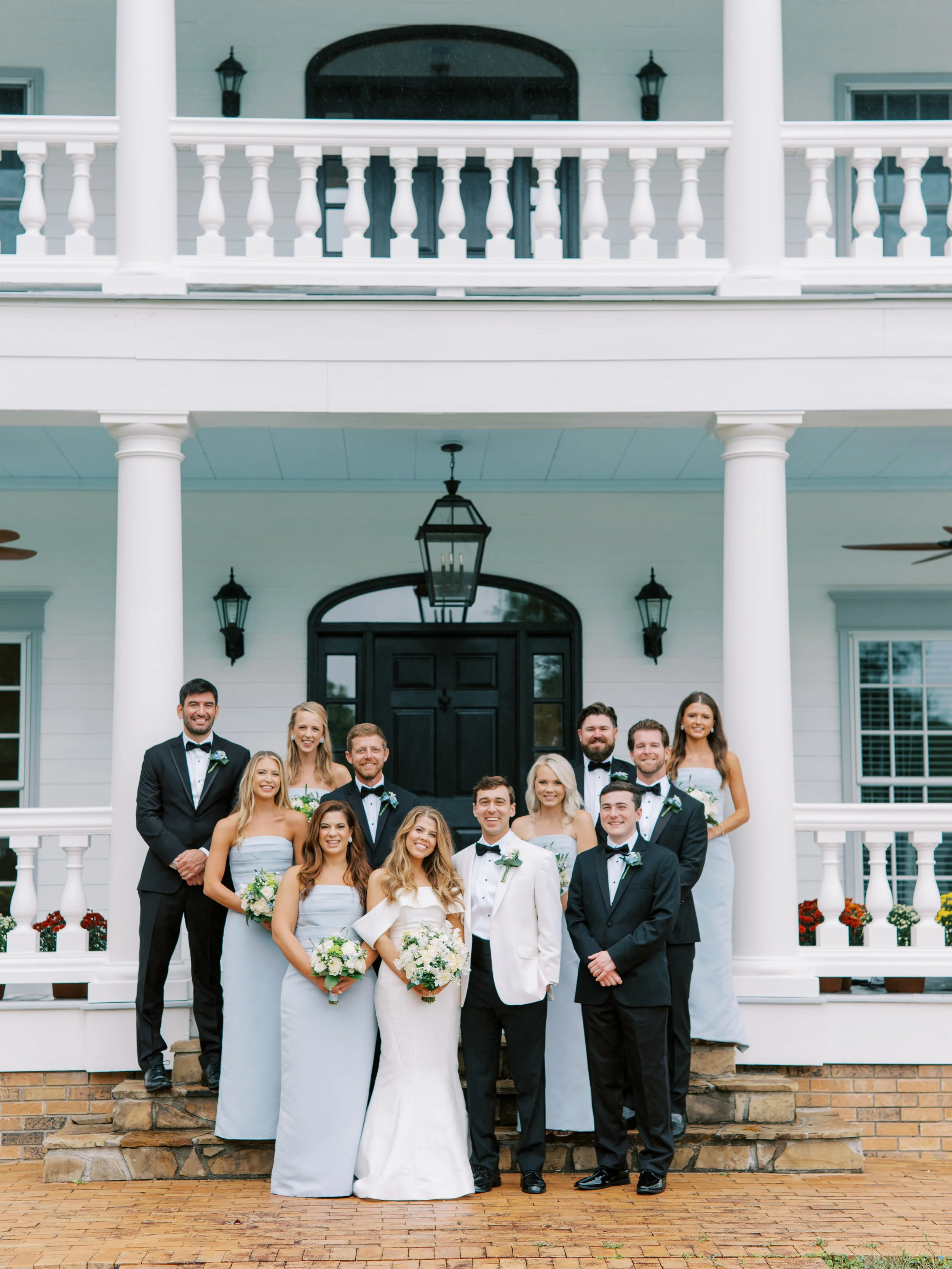 Wedding party posed together on the plantation house steps
