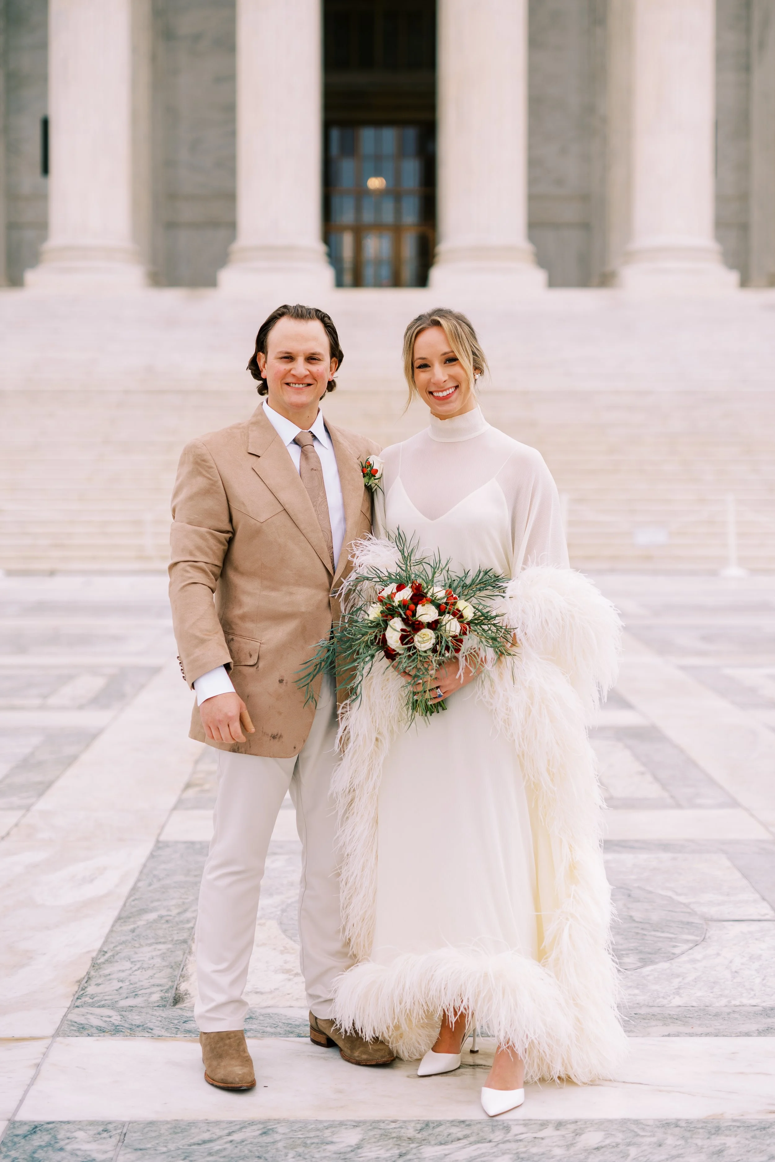 Bride and groom smiling together in front of a grand columned Washington DC building