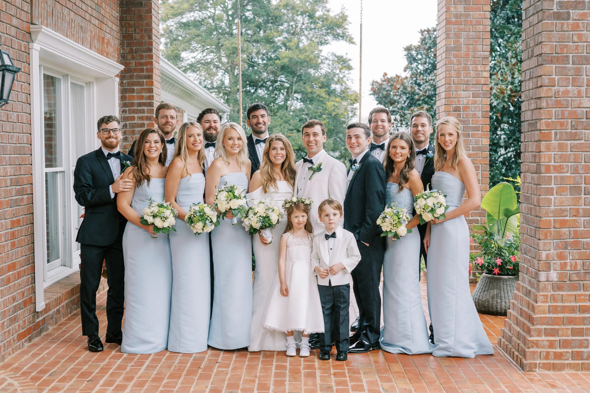 Full wedding party formal portrait with flower girl at the porte-cochere