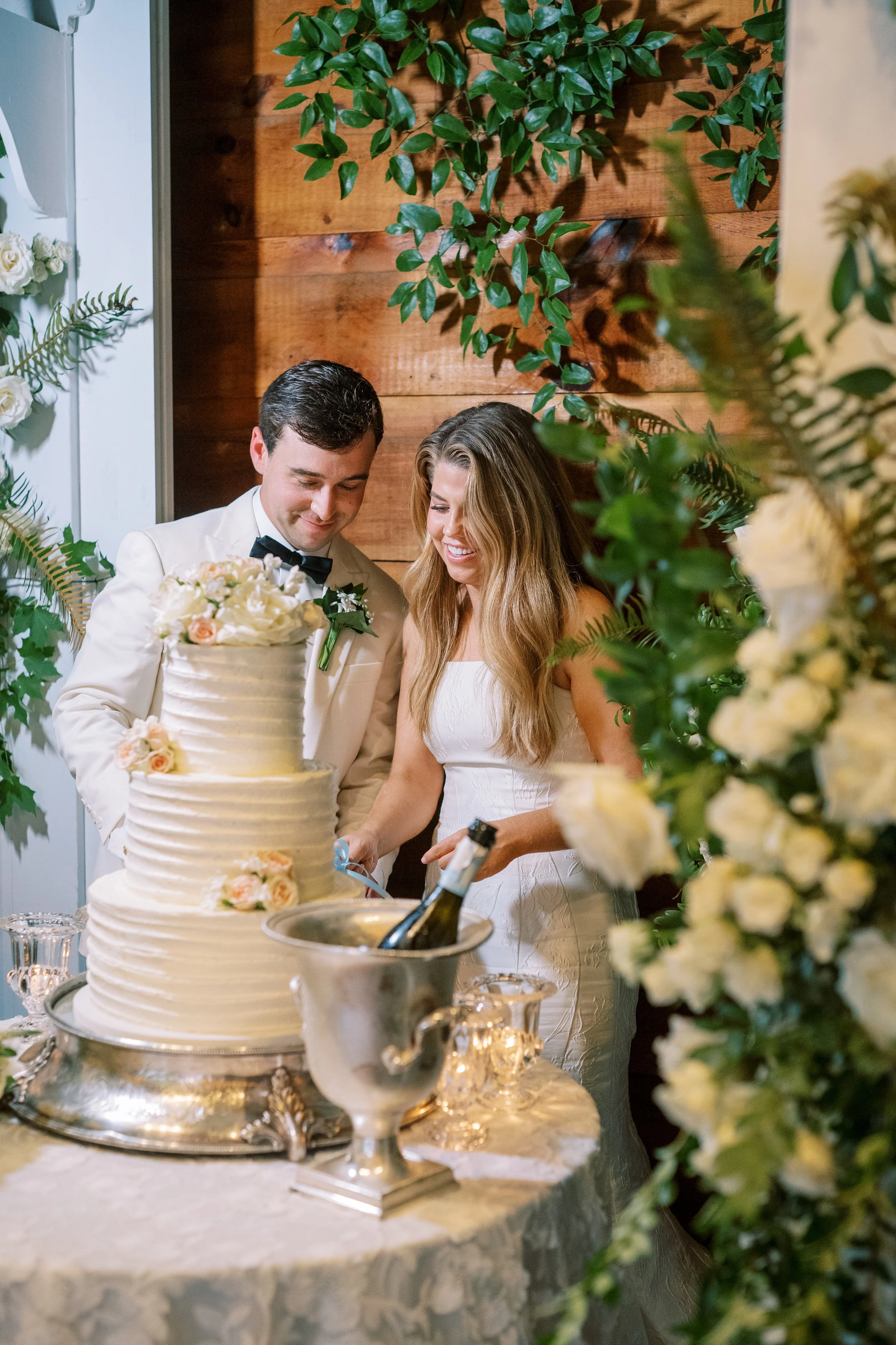 Bride and groom cutting the wedding cake together