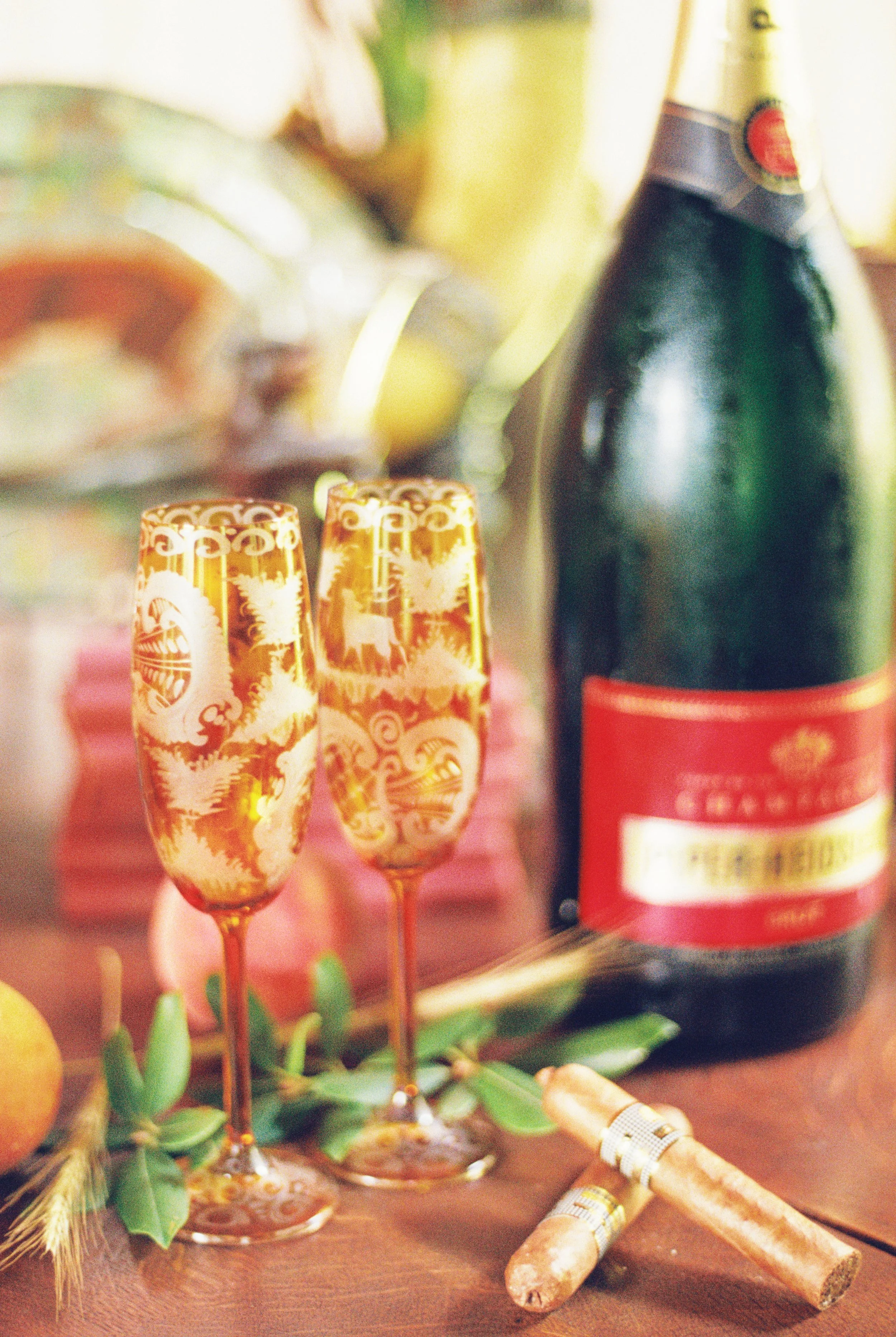 Two champagne flutes and a bottle set out for the wedding toast