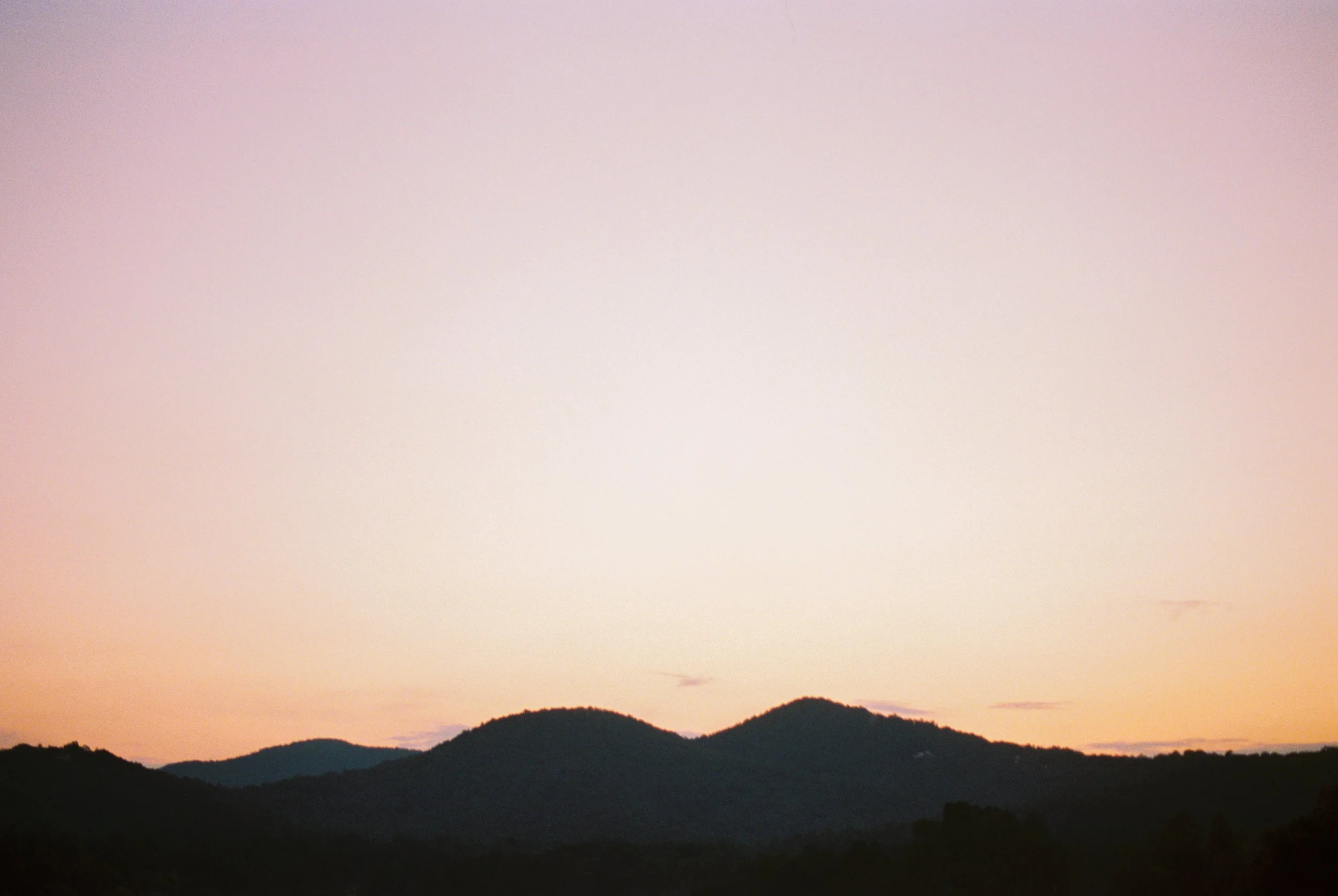 Sunset over the mountains surrounding Lake Rabun, pink and orange sky