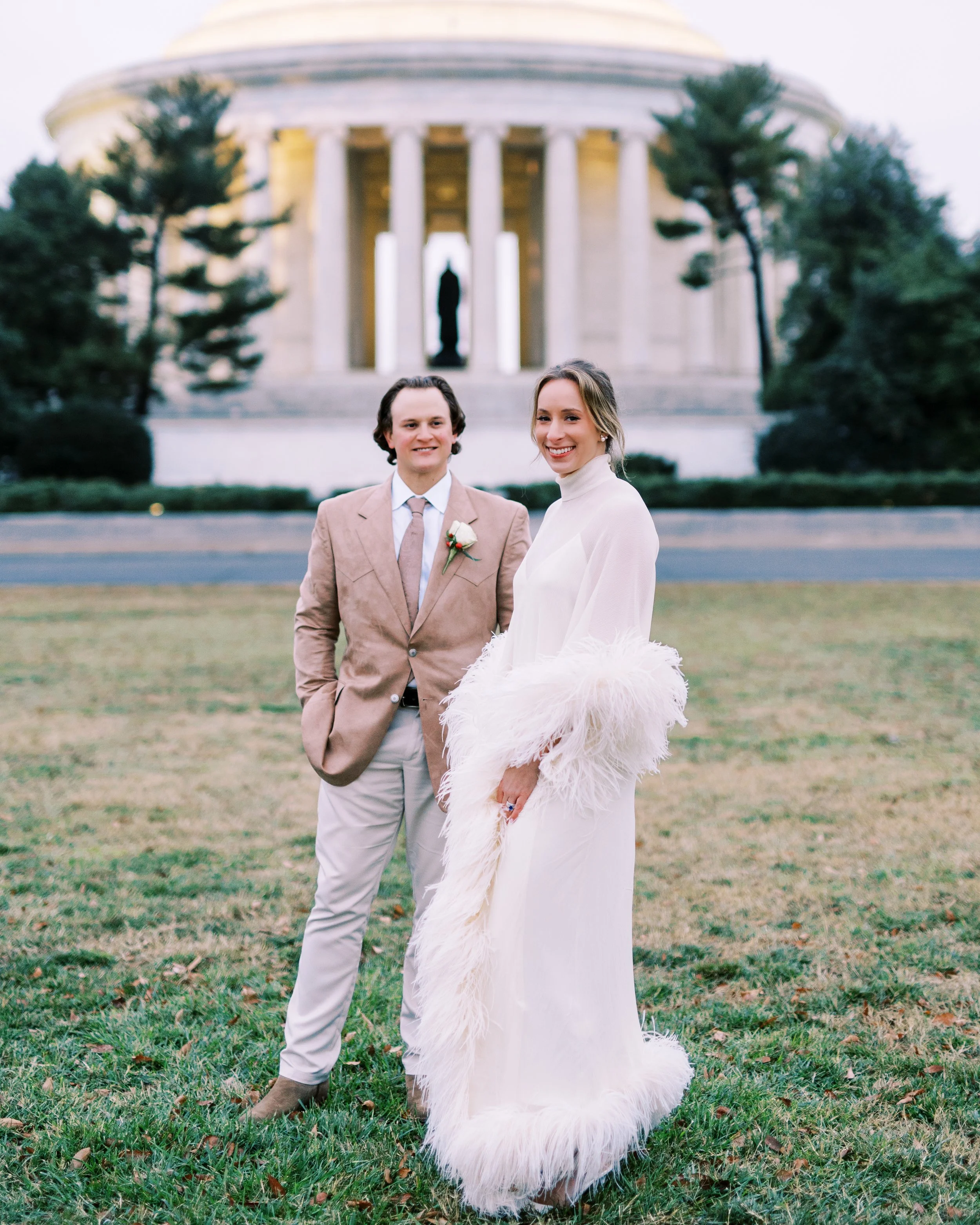 Bride and groom standing together on the lawn near the Jefferson Memorial at golden hour