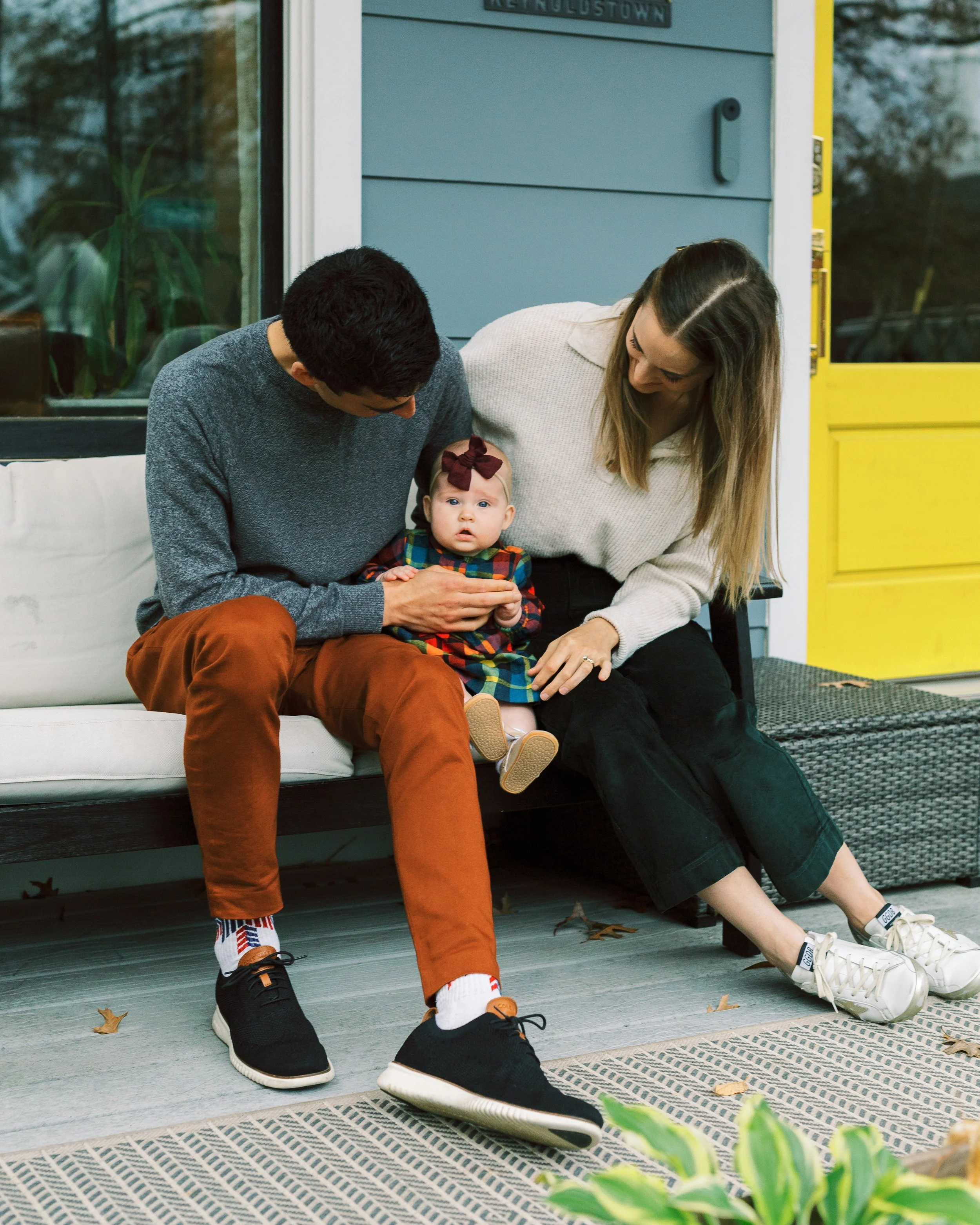 Family portrait on the front porch of their blue house, Reynoldstown, Atlanta, Georgia