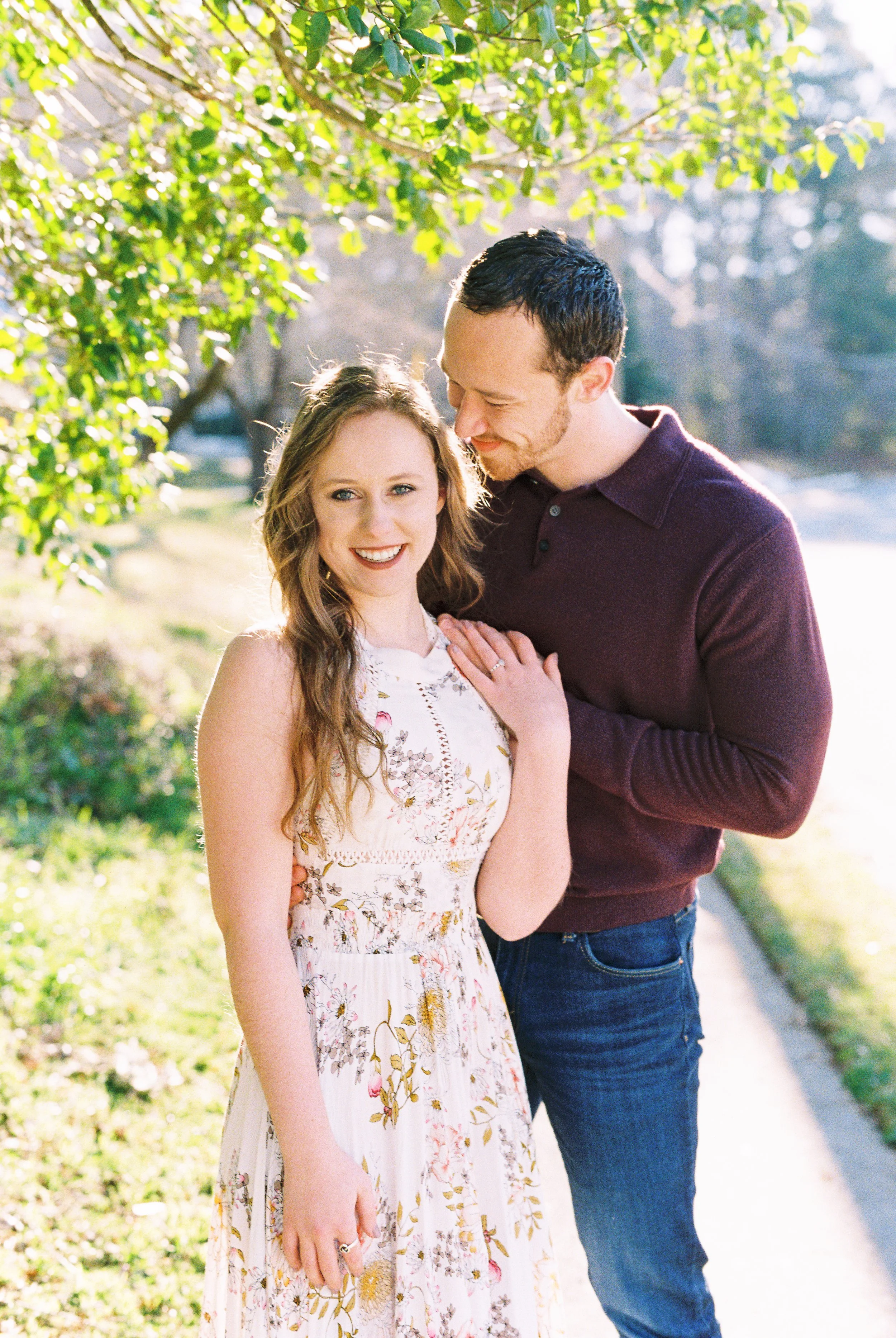 Maddie smiles at the camera as Conner nuzzles her shoulder beneath a tree in Dallas, Georgia.