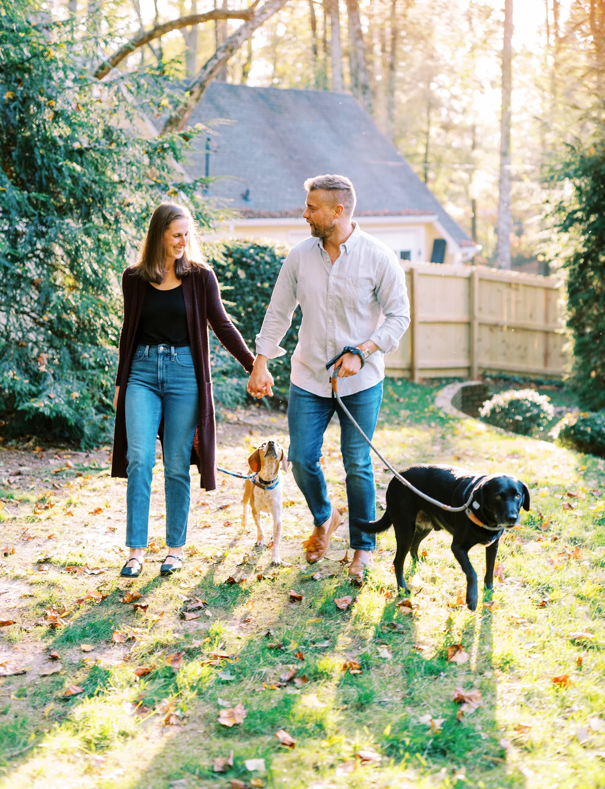Holly and Chris walking their two dogs together through the yard in Dunwoody, Georgia