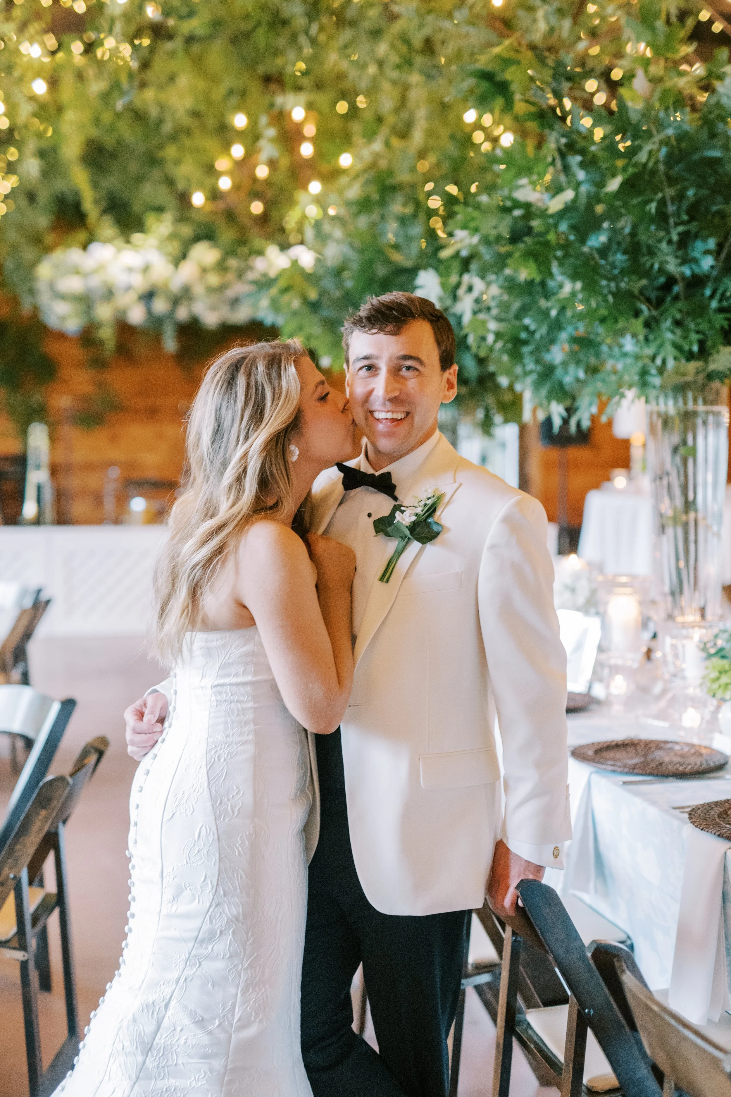 Bride and groom laughing together at the reception