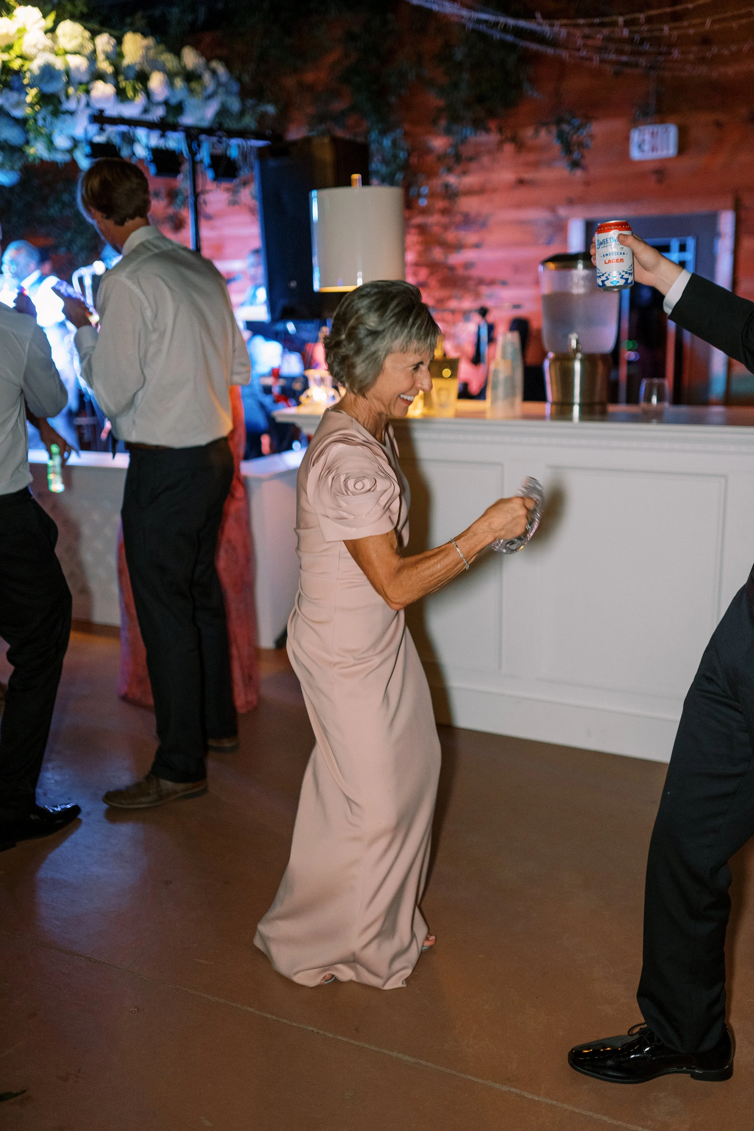 Guest dancing near the reception bar at night