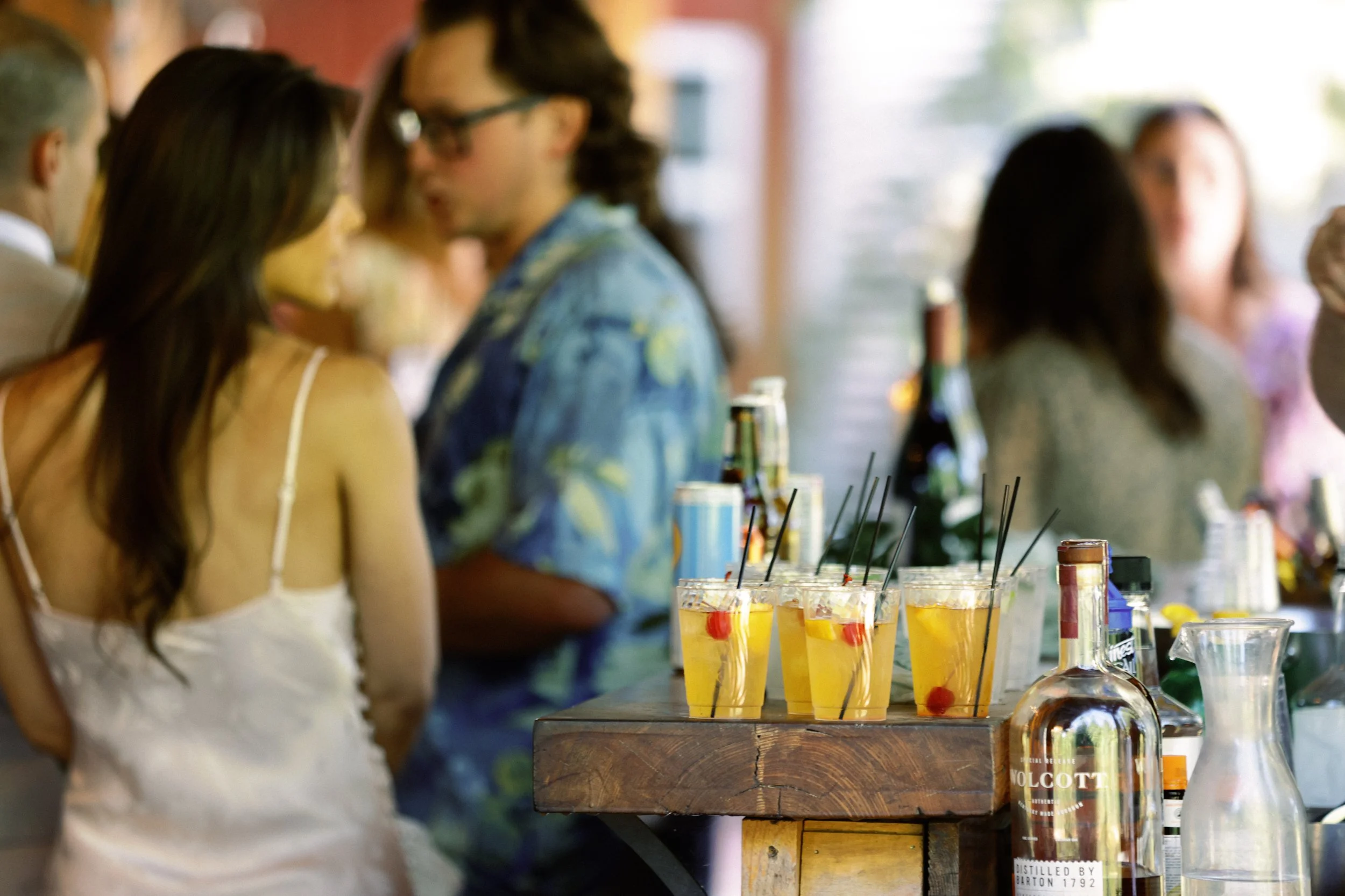 Wedding guests gathered at the outdoor drink station during cocktail hour