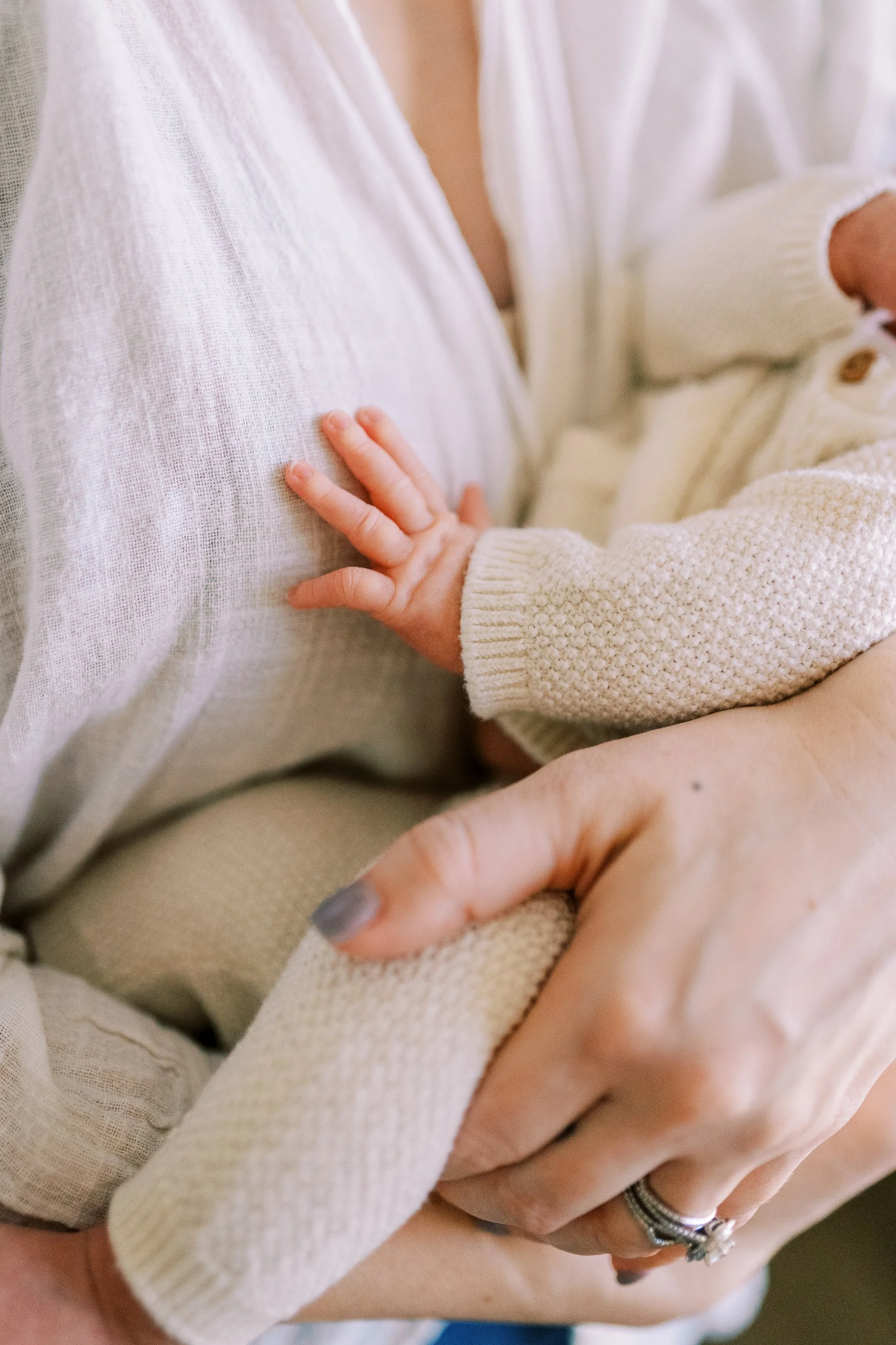 Close-up of newborn baby resting in his mother's arms, Roswell, Georgia