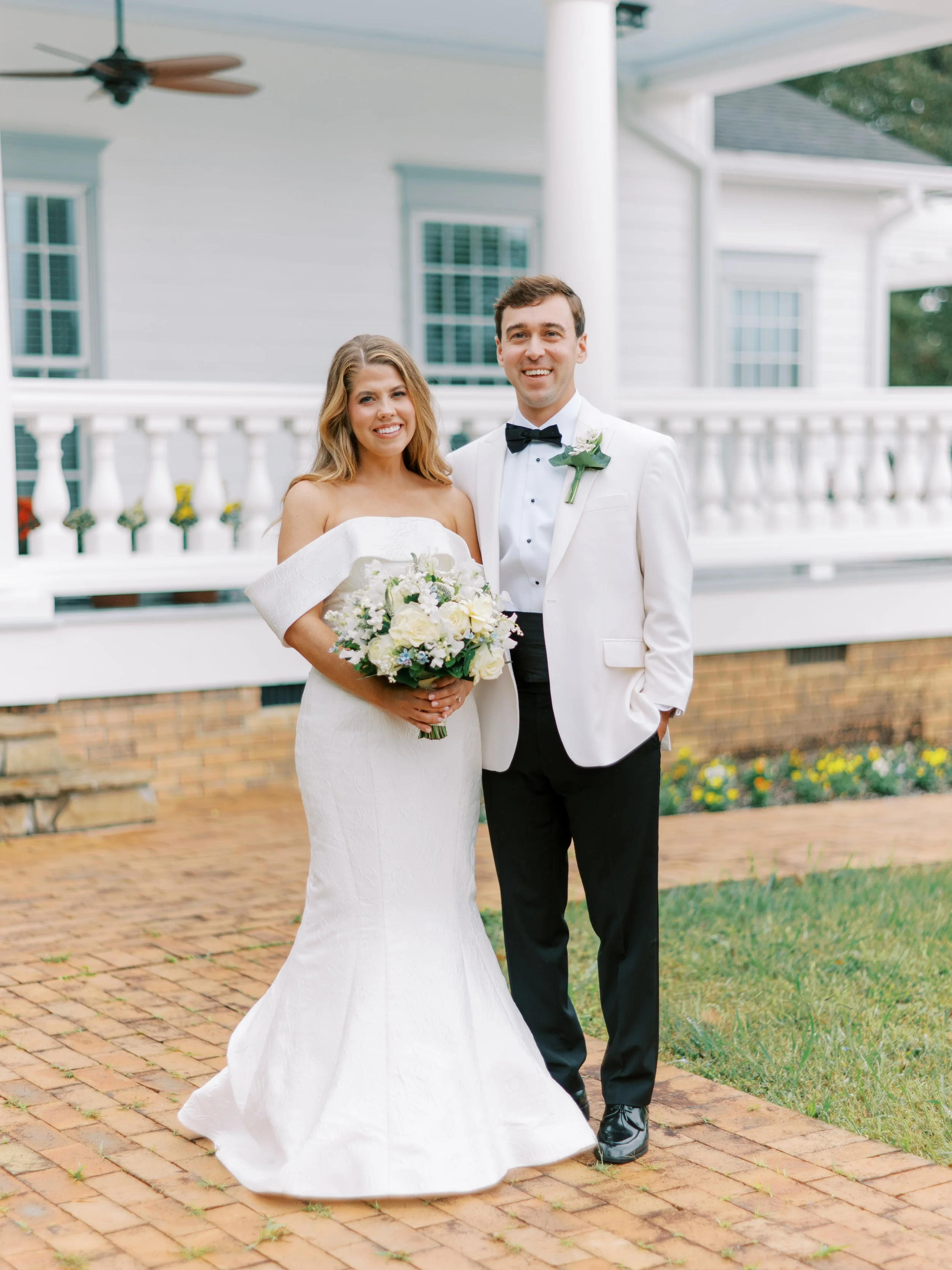 Bride and groom portrait in front of the plantation house porch