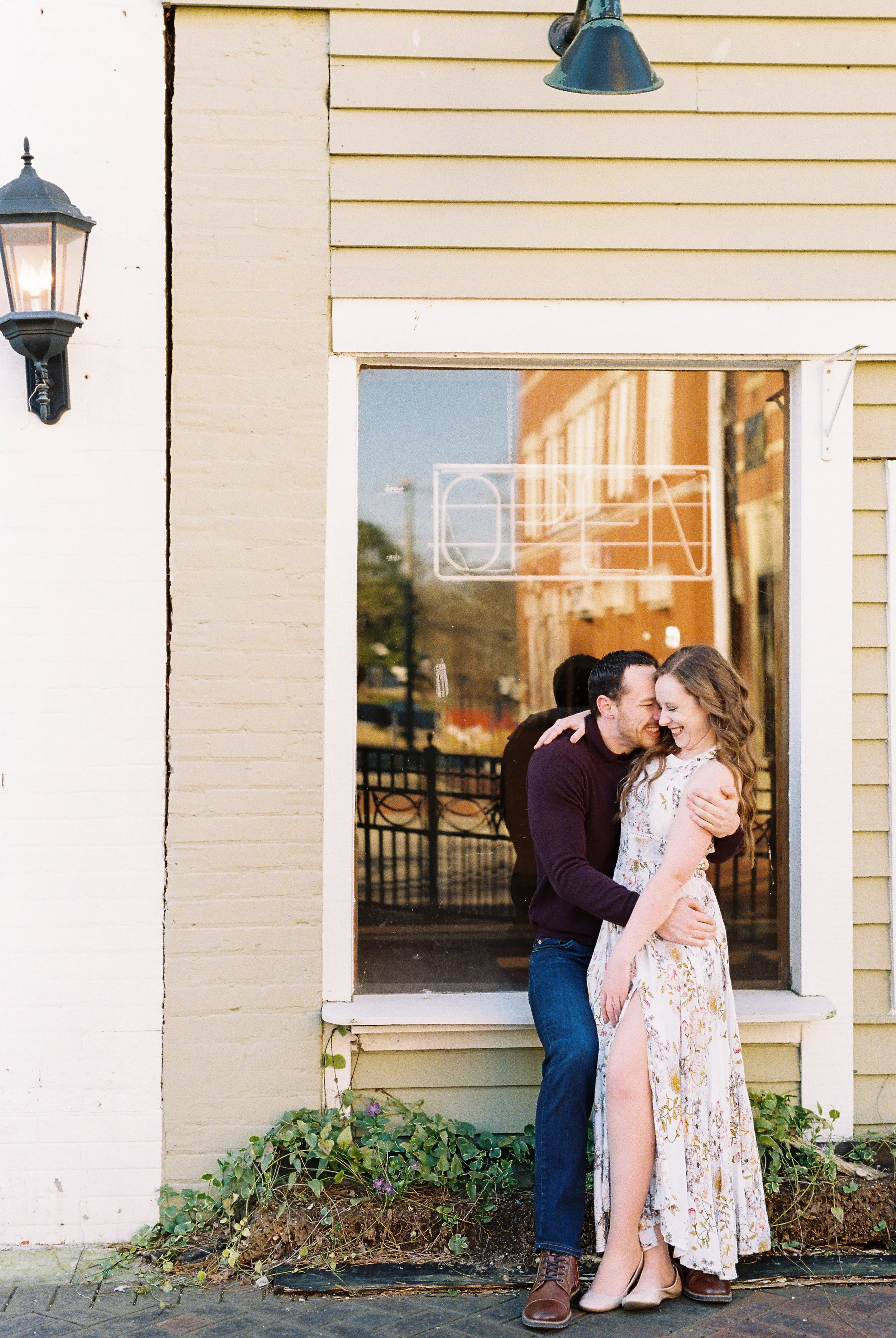 Conner nuzzles Maddie's shoulder as they embrace outside a storefront in downtown Dallas, Georgia.