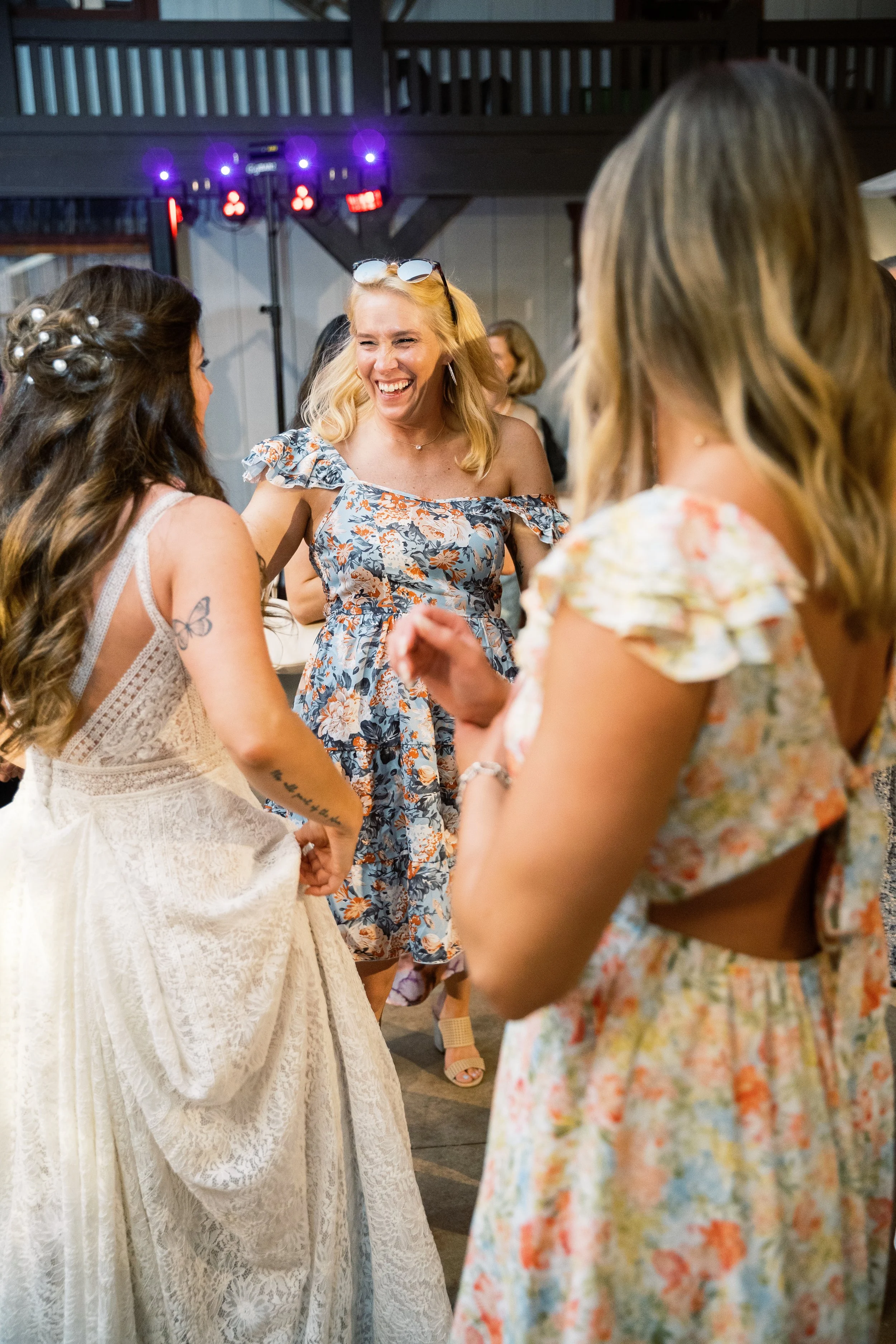 Group of women laughing and dancing together on the dance floor