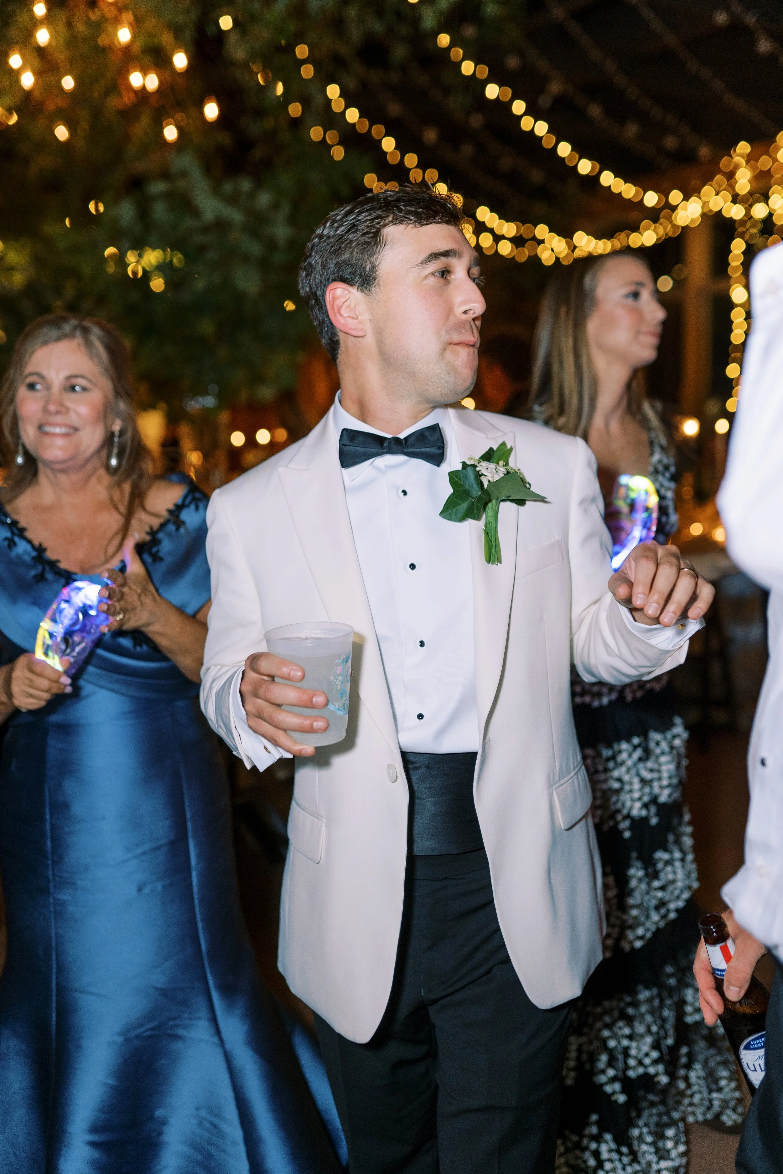 Groom dancing and mingling with guests at the reception