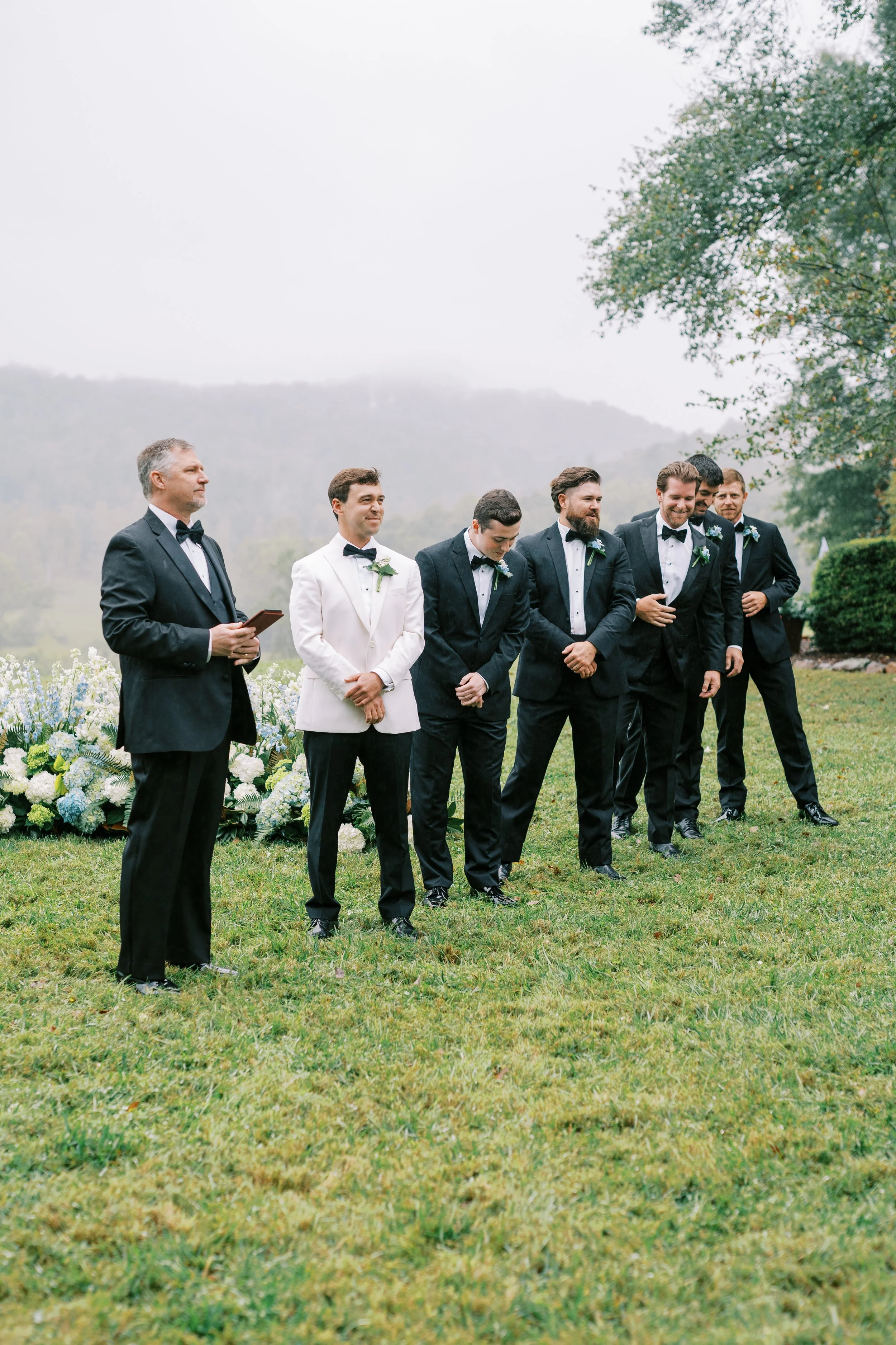 Groom standing with groomsmen waiting at the ceremony site