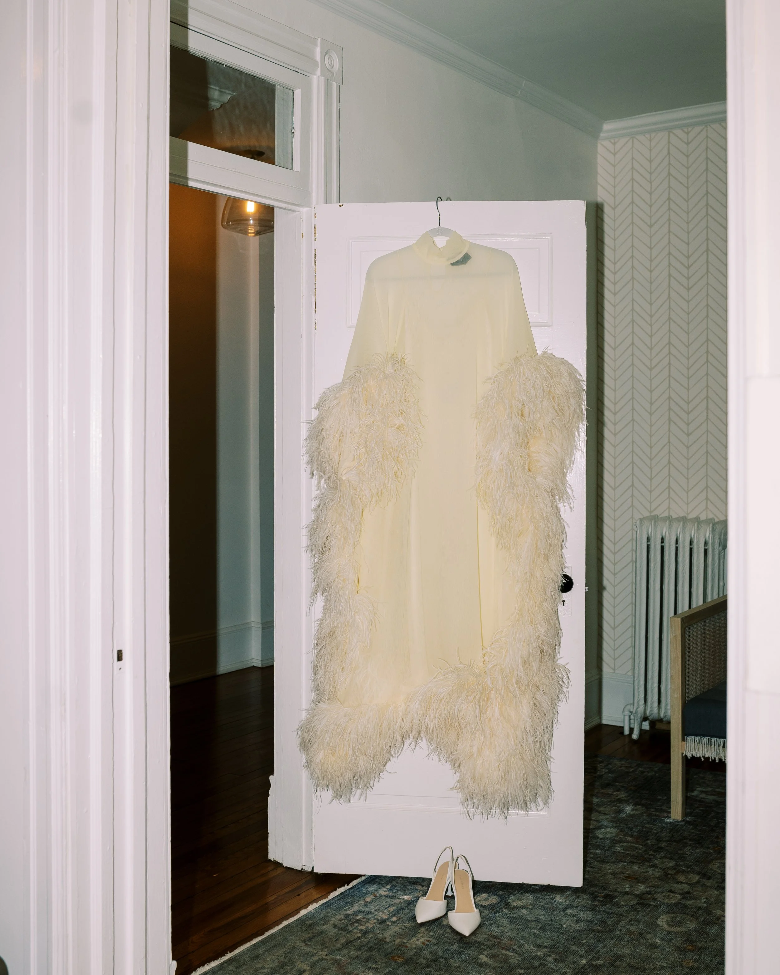 Bridal fur coat hanging on a doorway before the ceremony