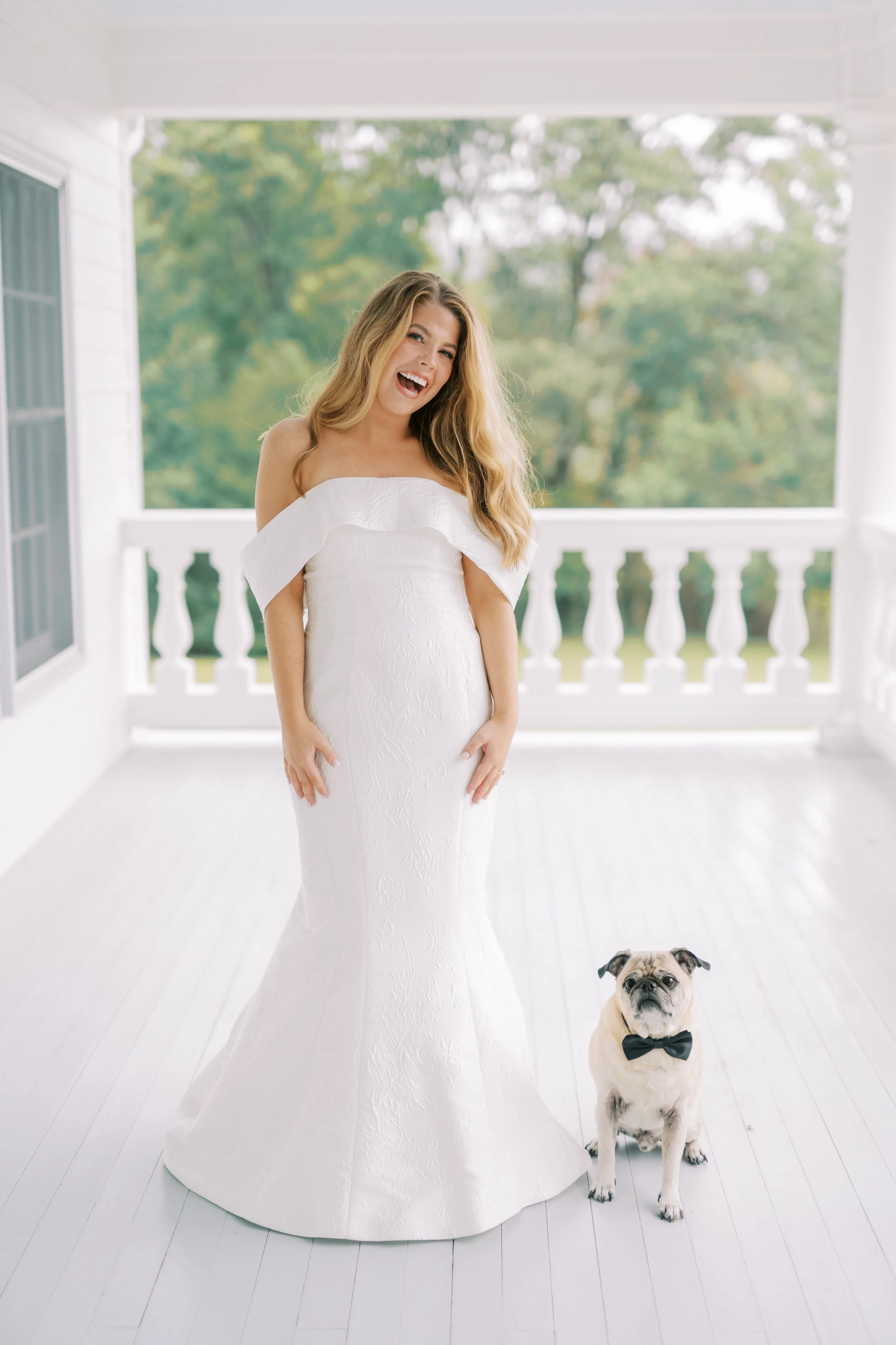 Bride solo portrait on the porch with the family dog