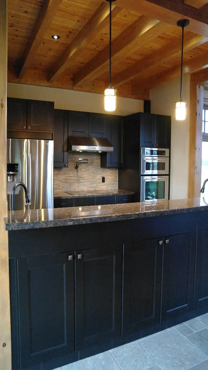 farmhouse dark kitchen with wood beams.jpg
