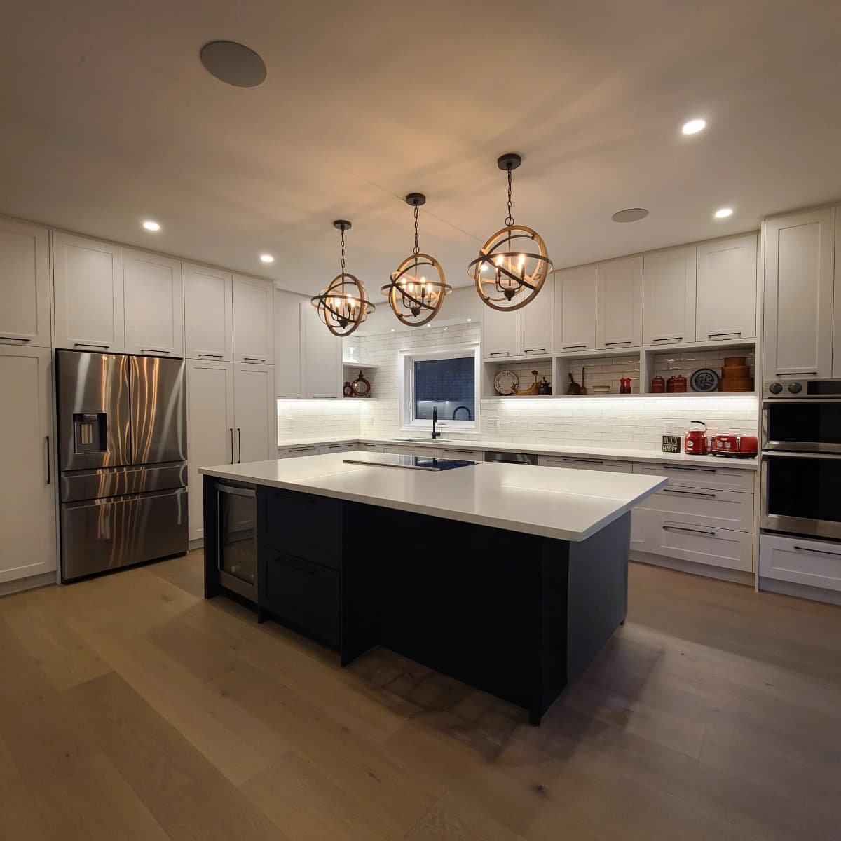 modern white framhouse kitchen with dark island.jpg
