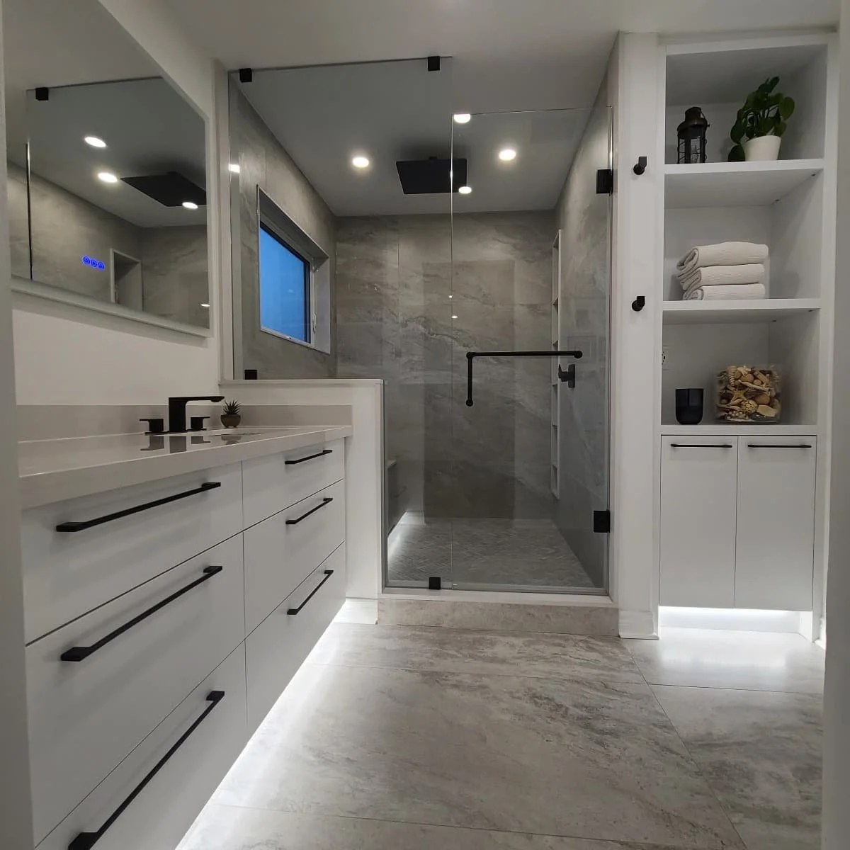 white and soft marble built in shower and floating vanity.jpg