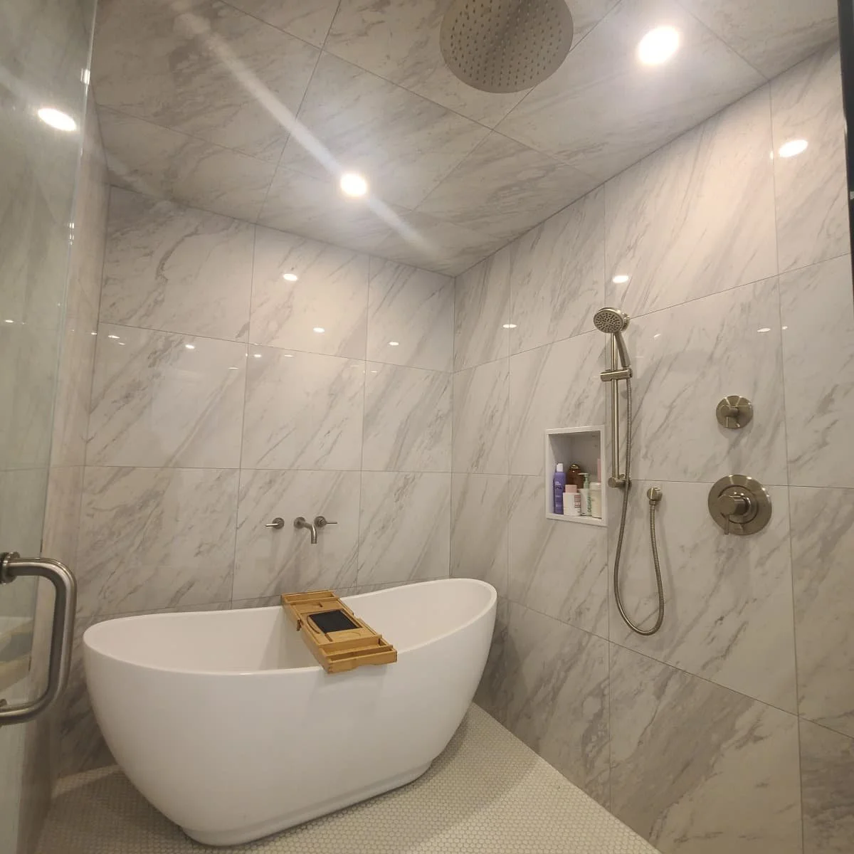 shower and tub combination room with soft veined marble.jpg