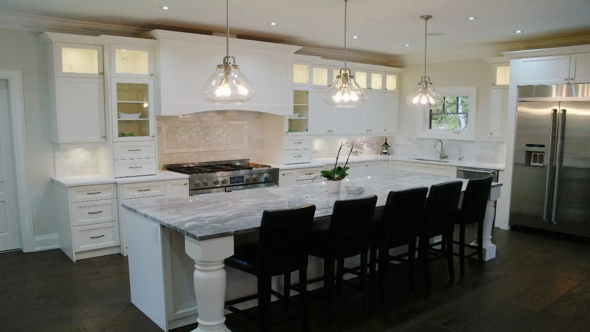 Transitional kitchen with white cabinetry and dark island.jpg