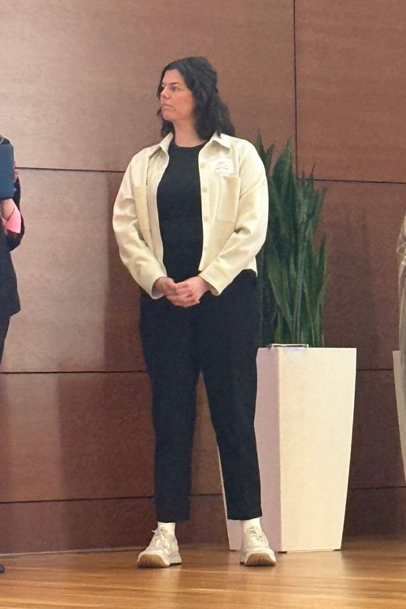 Laura Seelinger stands on stage at a women's event
