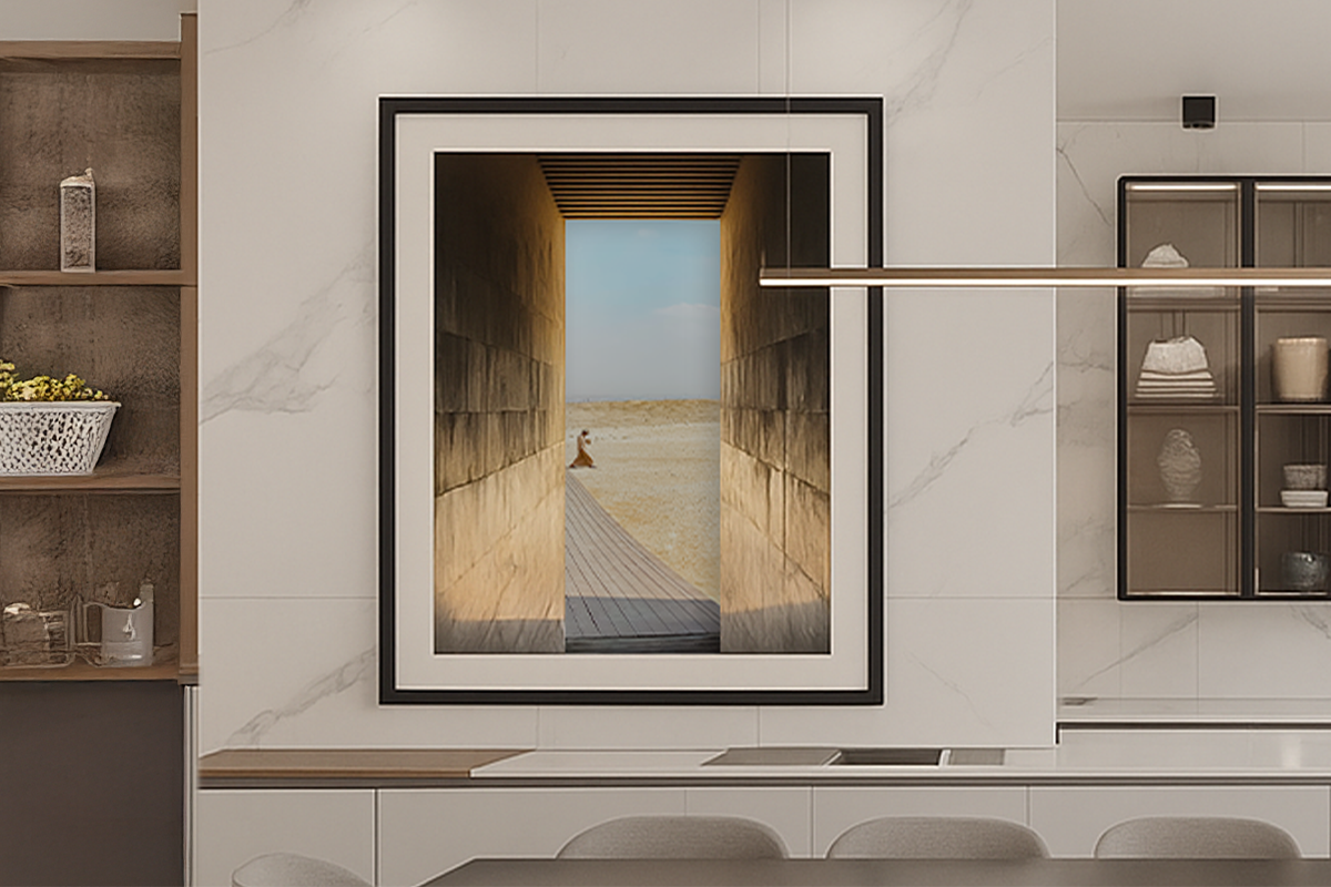 Architectural photograph of a narrow stone passage opening toward light and landscape, framed and displayed in a contemporary interior by Jay Britto.