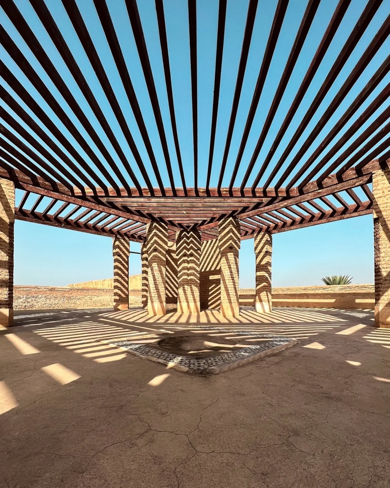 Golden light washes over the ancient walls of El Badi Palace, capturing Marrakech&rsquo;s timeless charm from a serene rooftop view. Warm terracotta textures, sweeping open sky, and subtle shadows create an atmospheric blend of history and tranquilit